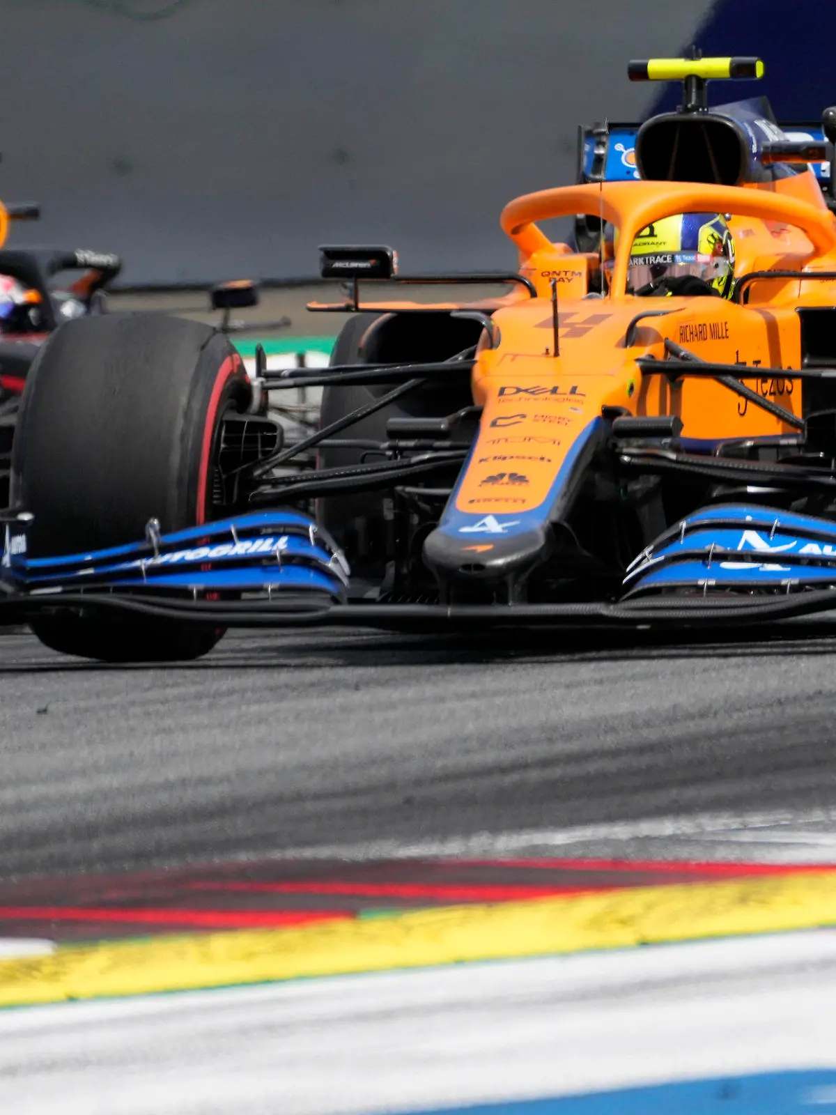 Mclaren driver Lando Norris of Britain leads ahead of Red Bull driver Sergio Perez of Mexiconduring the Styrian Formula One Grand Prix at the Red Bull Ring racetrack in Spielberg, Austria, Sunday, June 27, 2021. (AP Photo/Darko Vojinovic)