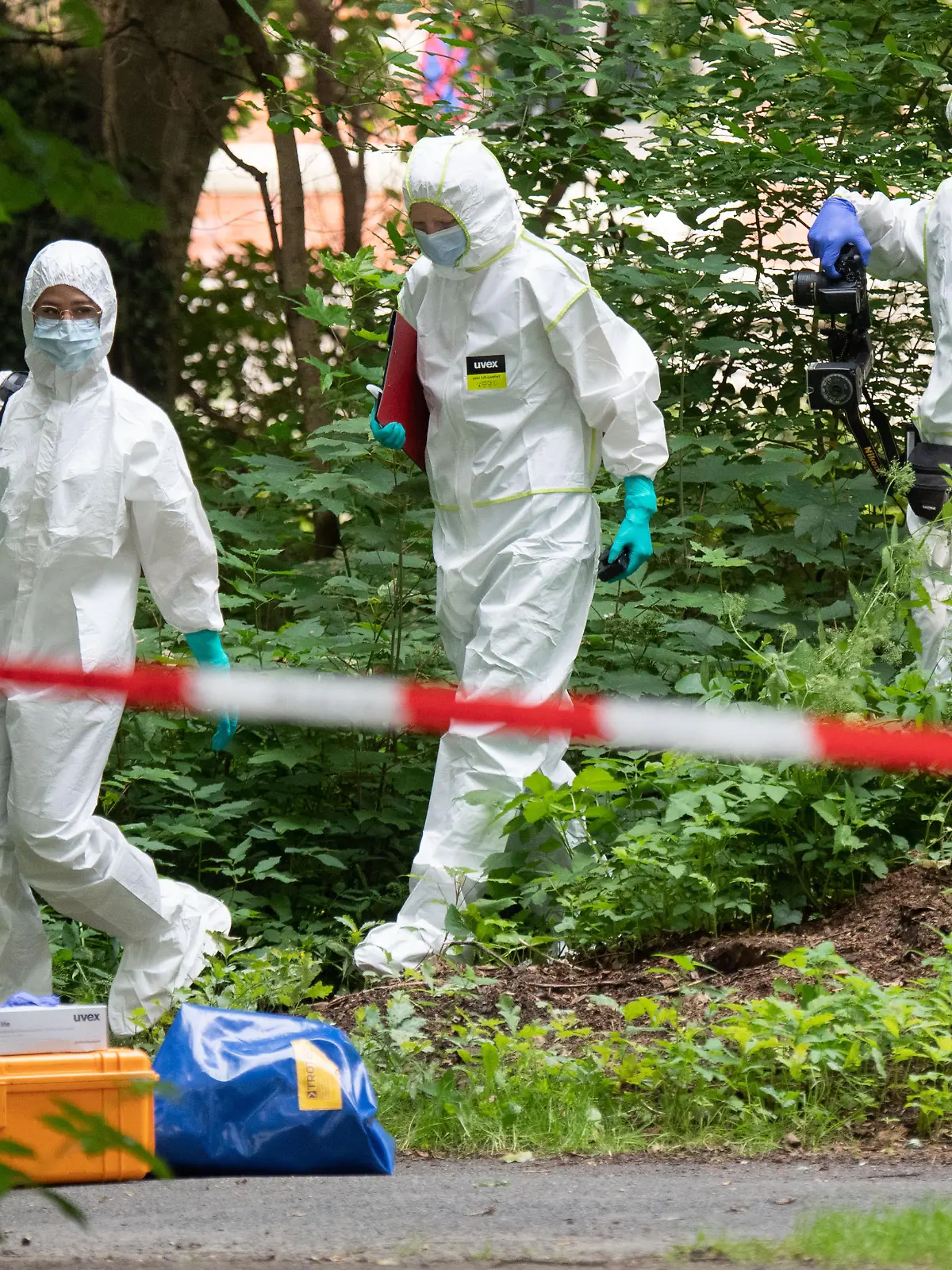Mitarbeiter der Spurensicherung der Polizei Hannover stehen im Stadtwald Eilenriede. Auf einer Parkbank in Hannover ist am 06. Juli 2021 ein Mann tot aufgefunden worden.