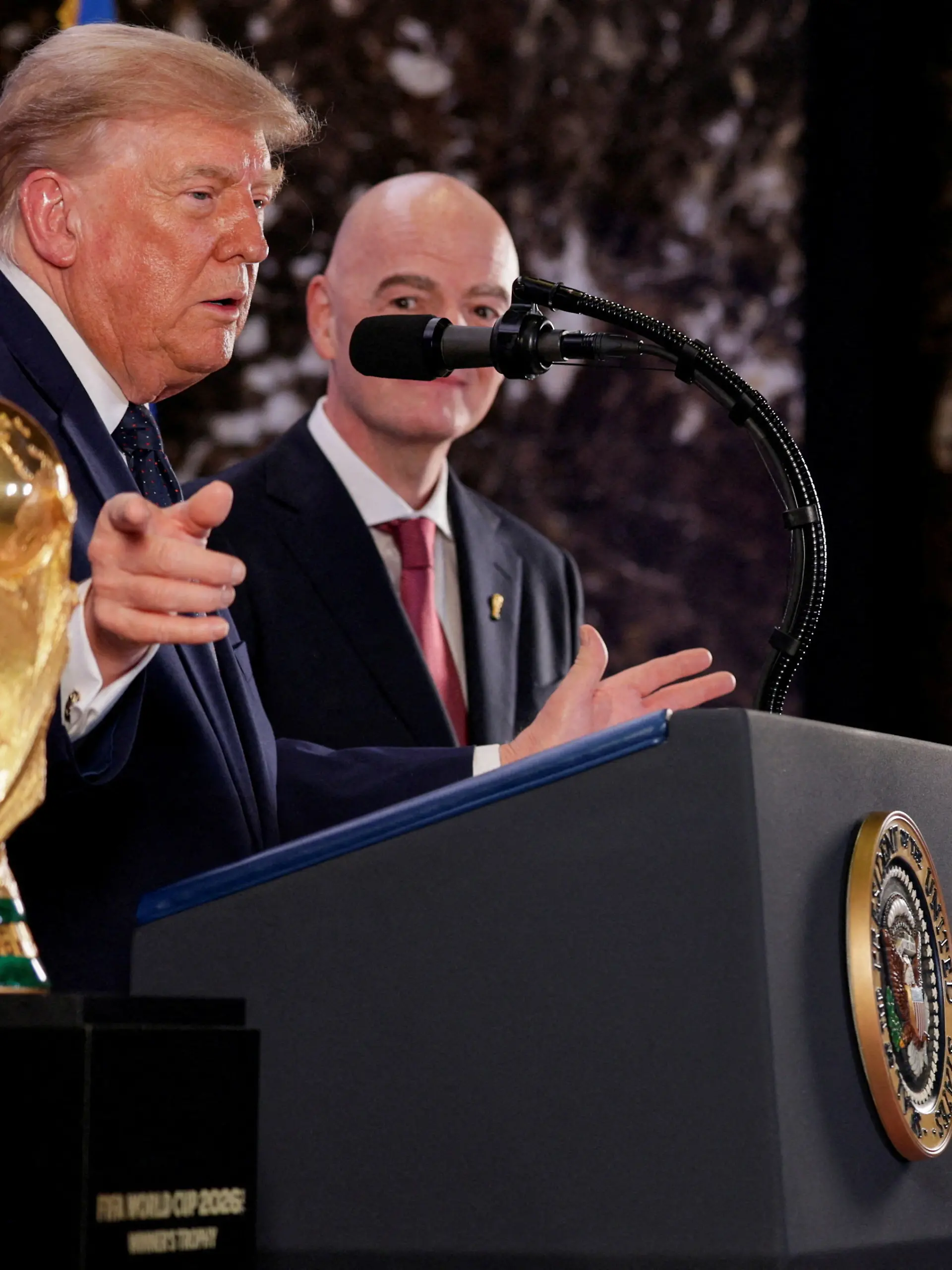 U.S. President Donald Trump, flanked by FIFA President Gianni Infantino, gestures while speaking next to FIFA World Cup Trophy, as they attend a FIFA reception at Trump Tower in New York City, U.S., July 17, 2026. REUTERS/Evan Vucci TPX IMAGES OF THE DAY