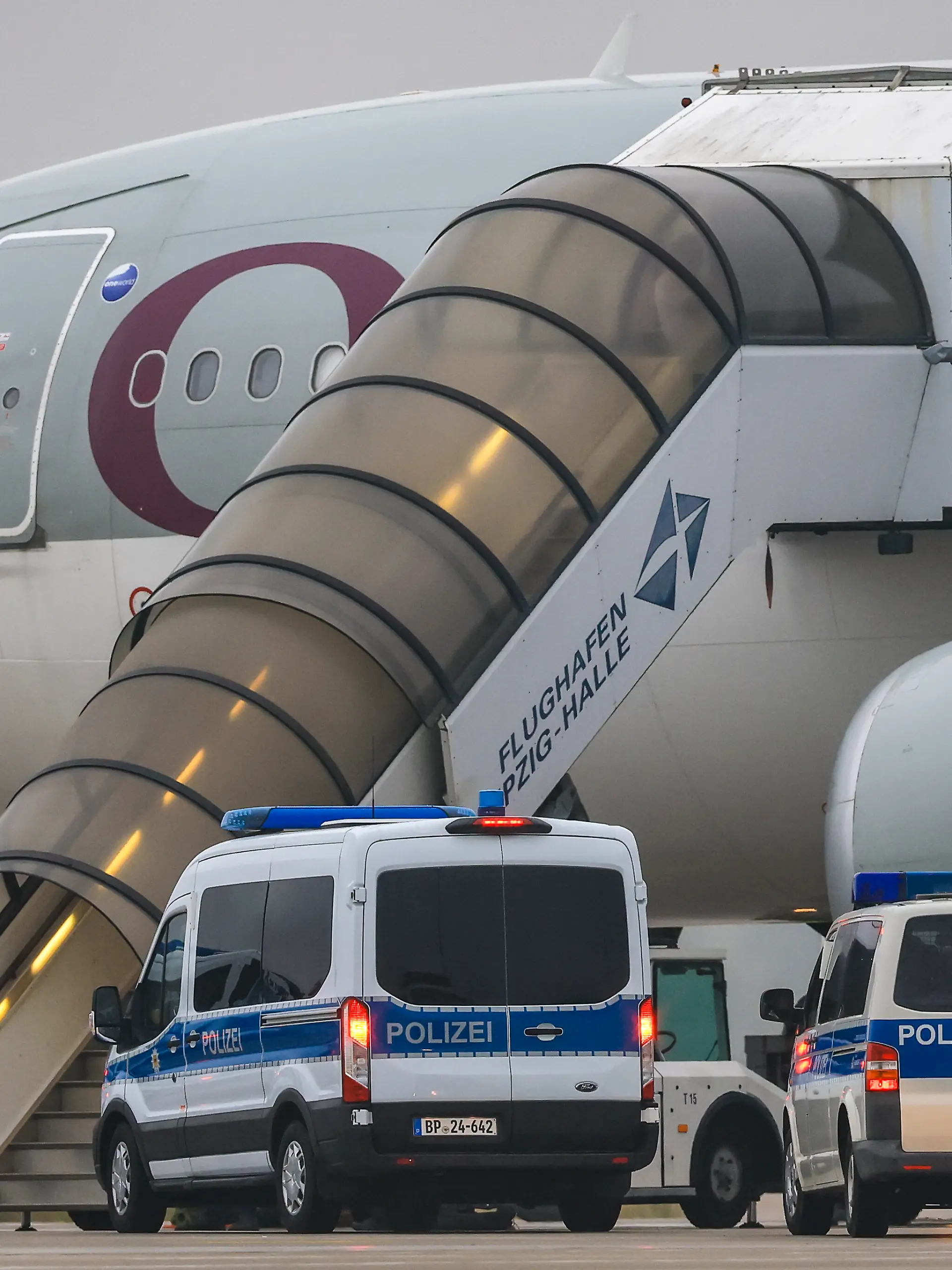 Polizeifahrzeuge stehen vor einem Flugzeug der Qatar Airways auf dem Flughafen Leipzig/Halle. Wie eine Sprecherin des Bundesinnenministeriums bestätigte, startet das Flugzeug vom Flughafen in Leipzig aus mit 81 Menschen an Bord, um diese in ihr Herkunftsland Afghanistan zurückzubringen. Deutschland schiebt damit zum zweiten Mal seit der Machtübernahme durch die Taliban im August 2021 afghanische Staatsangehörige in ihr Herkunftsland ab.