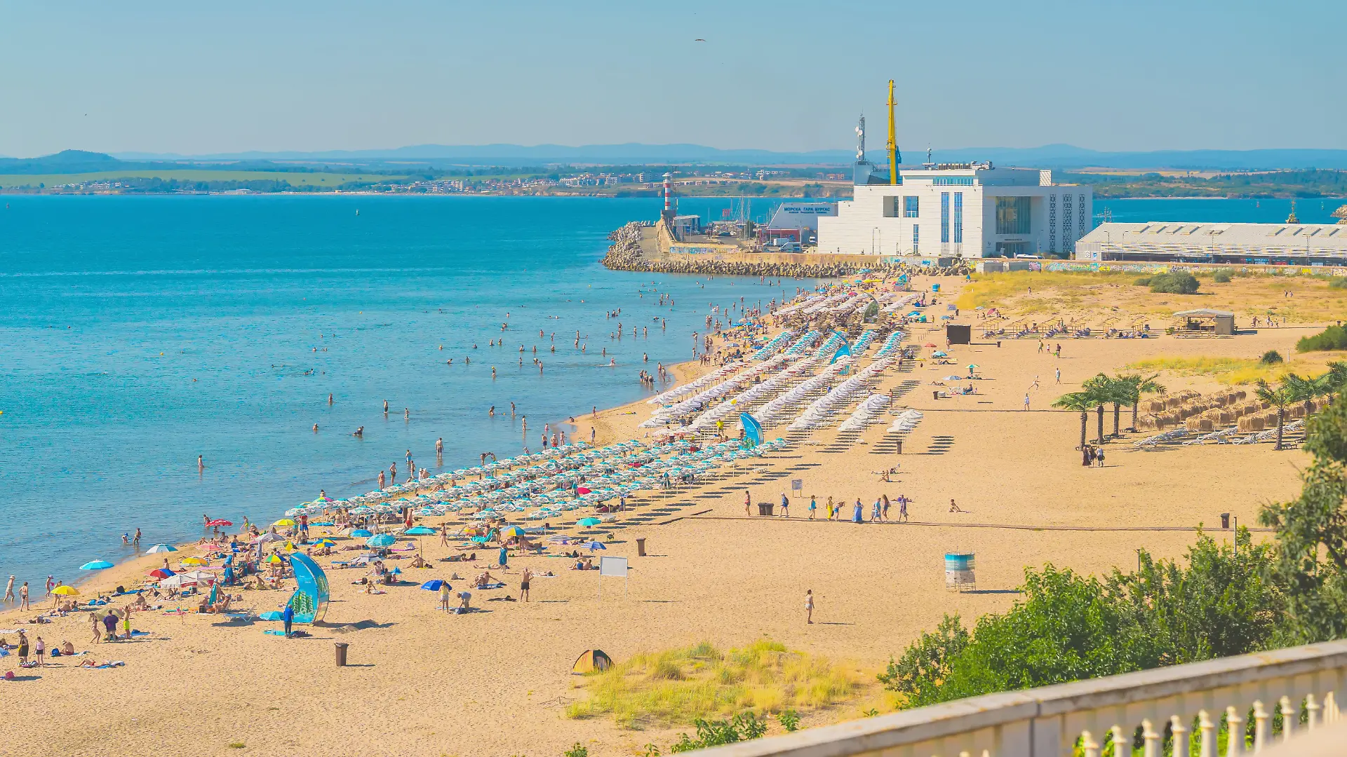 Burgas, Bulgaria - July 11, 2026: Crowded Burgas beach and Sea Station during summer season. Visitors swim and relax on crowded city beach near Burgas Sea Station on sunny summer day