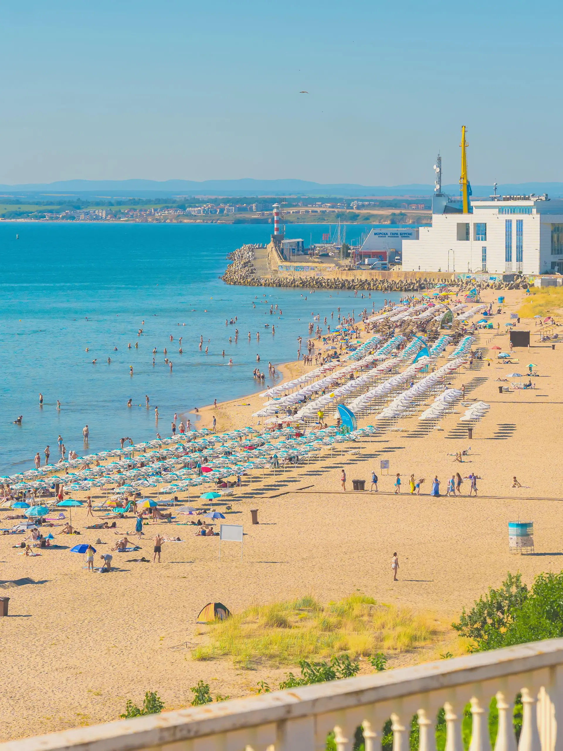 Burgas, Bulgaria - July 11, 2026: Crowded Burgas beach and Sea Station during summer season. Visitors swim and relax on crowded city beach near Burgas Sea Station on sunny summer day