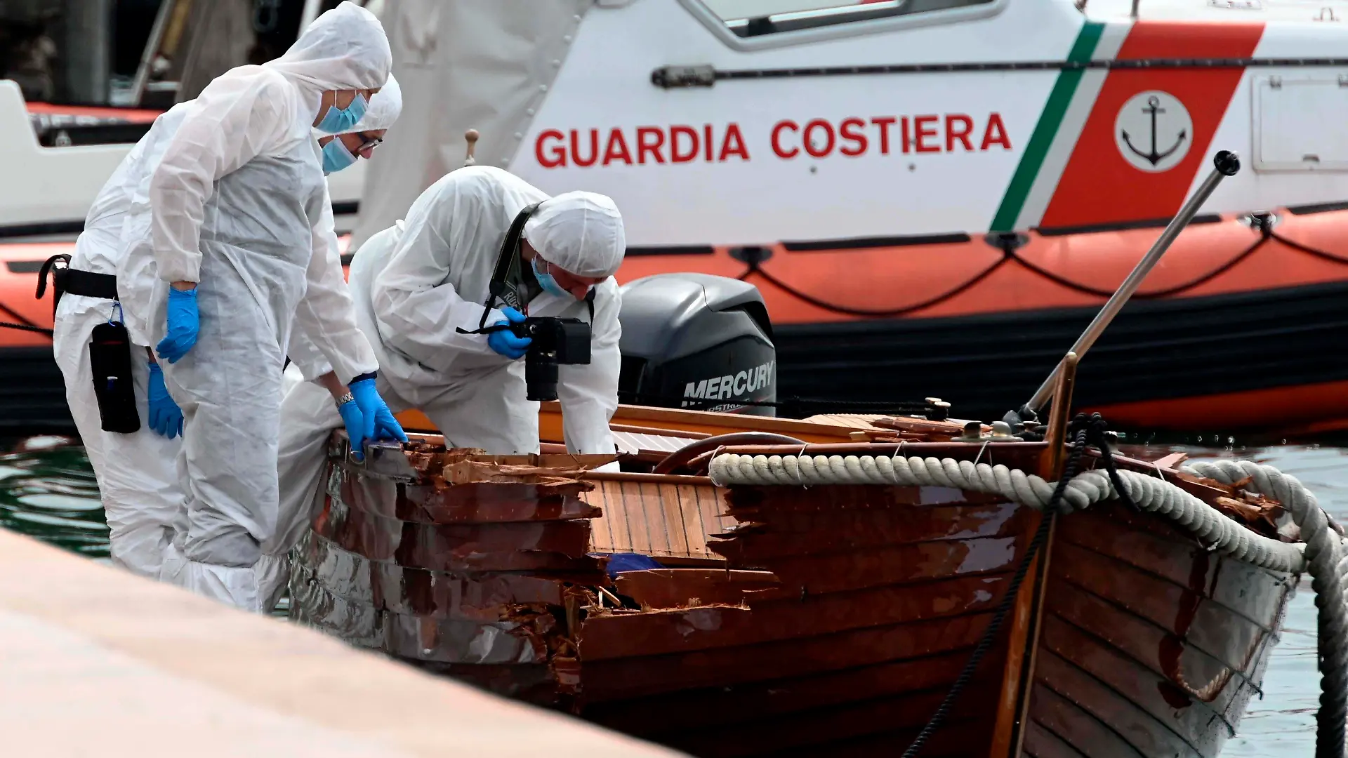ARCHIV - 20.06.2021, Italien, Salo: Italienische Forensiker begutachten den Schaden an einem Boot. Die italienische Justiz hat im Fall des tödlichen Bootsunglücks auf dem Gardasee in Norditalien einen europäischen Haftbefehl gegen einen der zwei deutschen Verdächtigen erlassen. (zu dpa «Tödlicher Bootsunfall auf Gardasee: Haftbefehl gegen Deutschen») Foto: Gabriele Strada/AP/dpa +++ dpa-Bildfunk +++