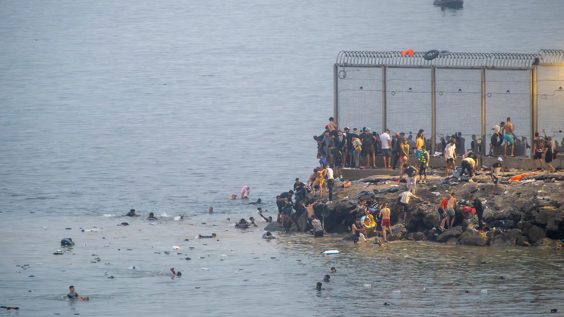Dozens of people attempt to cross the border in Ceuta, Spain on July 31, 2026, as the autonomous city wakes up to a constant stream of people arriving from Morocco, with thousands of migrants entering by swimming or on foot, skirting the breakwater that separates Ceuta from Morocco, while police sources state that more than 20,000 people are believed to have entered Spain. Photo by Marcos Moreno/Europa Press/ABACAPRESS.COM