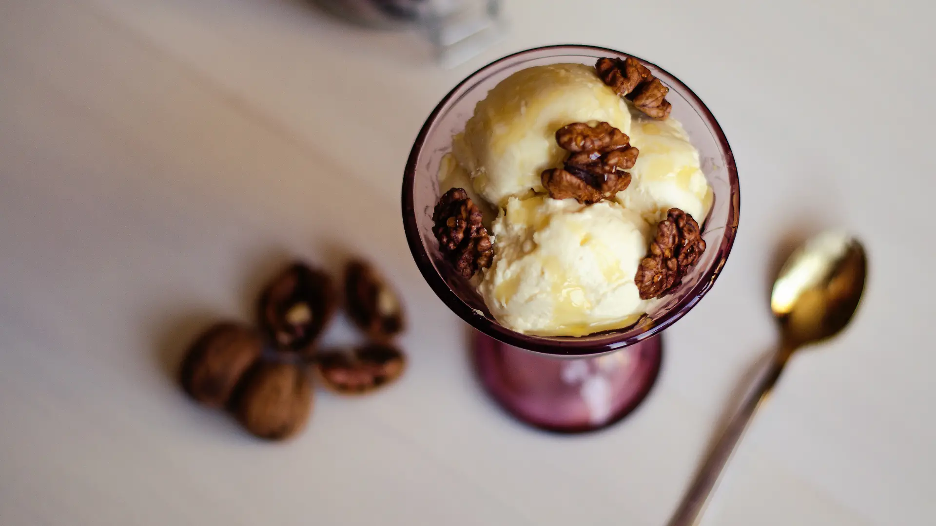 Getoppt wird das griechische Joghurt-Eis mit ein paar karamellisierten Walnüssen und Honig. 