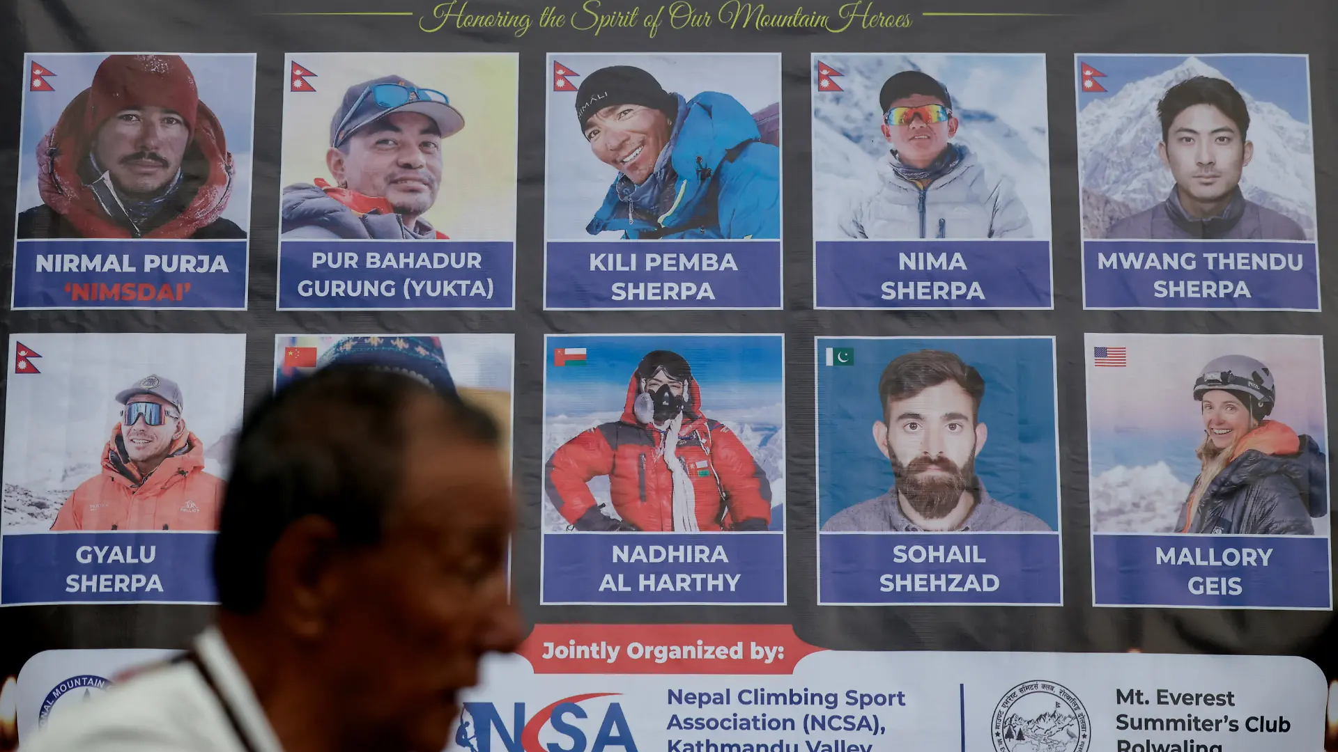 A man stands in front of the portraits of climbers who lost their life in an avalanche while summiting Broad Peak in Pakistan during a vigil to honour climbers, including celebrated British-Nepali climber Nirmal Purja, also known as Nimsdai, in Kathmandu, Nepal, August 4, 2026. REUTERS/Navesh Chitrakar