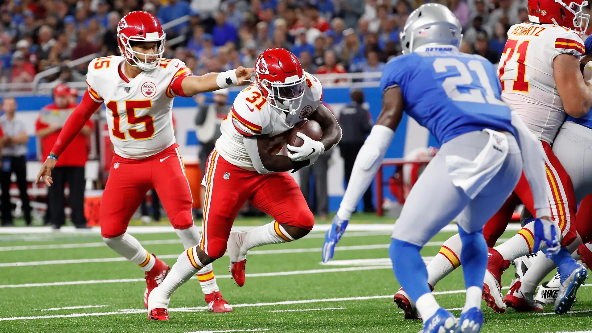 Kansas City Chiefs quarterback Patrick Mahomes (15) hands off to running back Darrel Williams (31) for a 1-yard touchdown rush during the second half of an NFL football game against the Detroit Lions, Sunday, Sept. 29, 2019, in Detroit. (AP Photo/Rick Osentoski)
