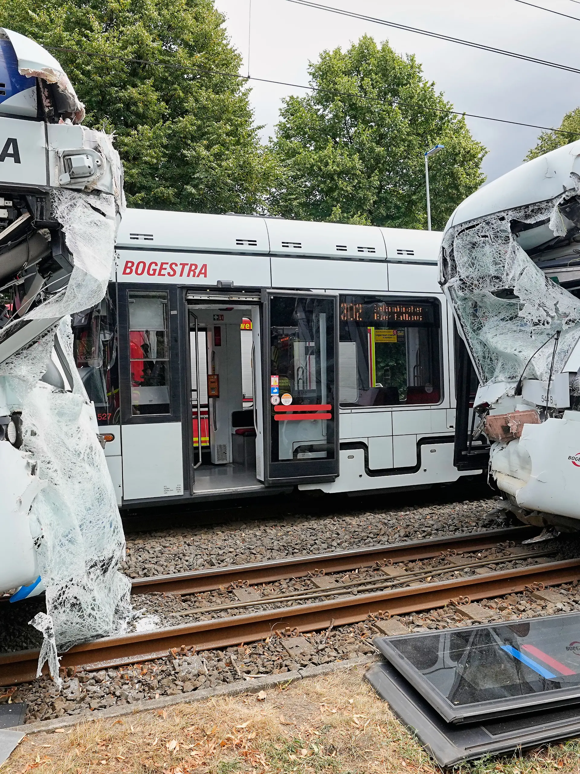 Emergency responders work at the scene of an accident where two trams collided in Gelsenkirchen, Germany, Thursday, Aug. 6, 2026. (AP Photo/Martin Meissner)