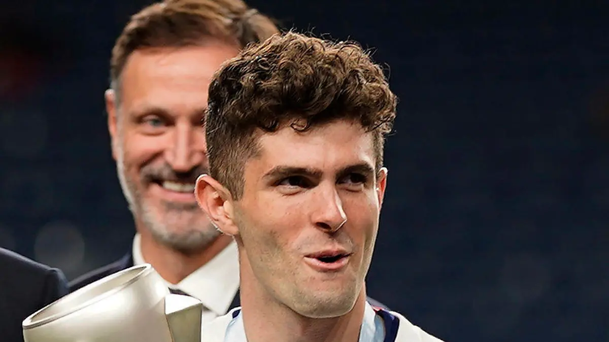 United States' Christian Pulisic (10) holds the championship trophy while celebrating their win against Mexico following the CONCACAF Nations League championship soccer match, Sunday, June 6, 2021, in Denver. (AP Photo/Jack Dempsey)