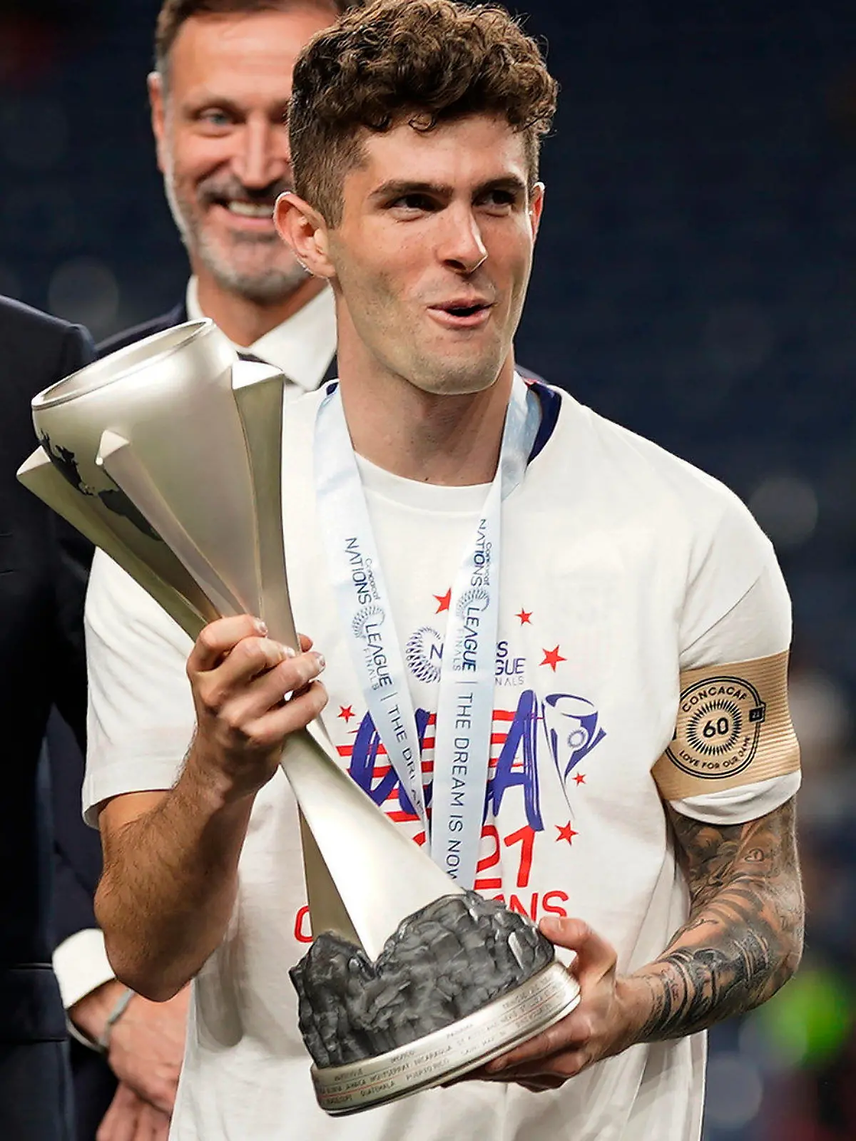 United States' Christian Pulisic (10) holds the championship trophy while celebrating their win against Mexico following the CONCACAF Nations League championship soccer match, Sunday, June 6, 2021, in Denver. (AP Photo/Jack Dempsey)