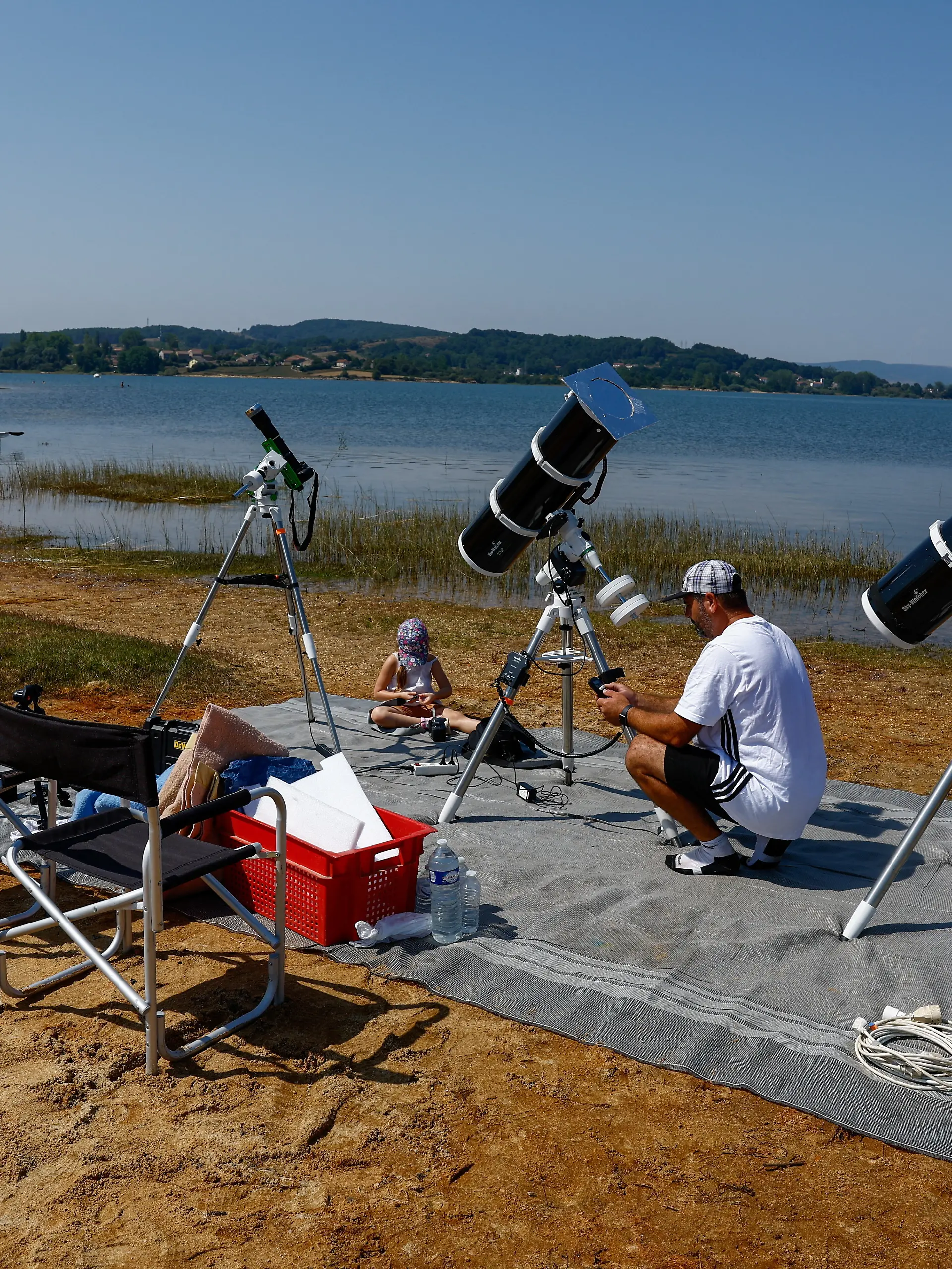 Frenchman Leyssalle Anthony, 39, prepares a telescope to view the total solar eclipse from the beach, in Arija, Spain, August 12, 2026. REUTERS/Borja Suarez