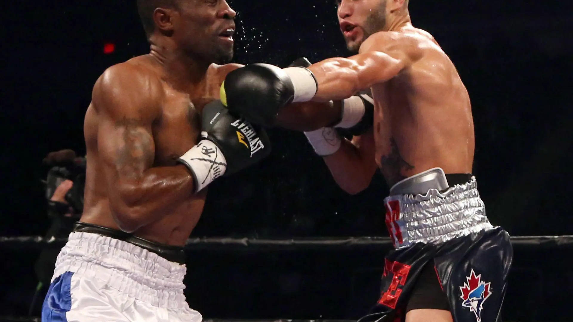 Prichard Colon, right, punches Vivian Harris during their WBC welterweight boxing match Friday, Sept. 11, 2015, in Toronto. (Peter Power/The Canadian Press via AP) MANDATORY CREDIT