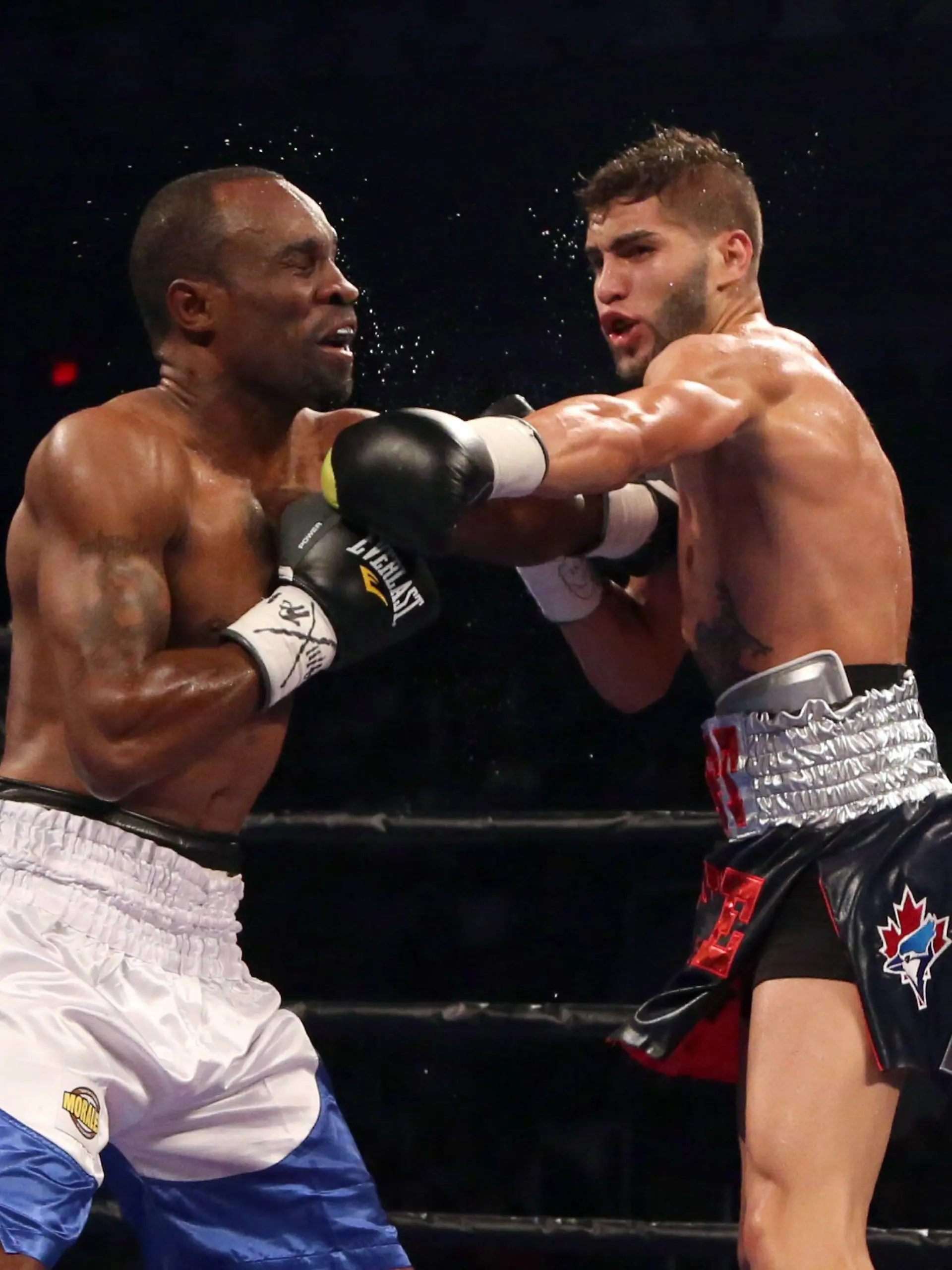 Prichard Colon, right, punches Vivian Harris during their WBC welterweight boxing match Friday, Sept. 11, 2015, in Toronto. (Peter Power/The Canadian Press via AP) MANDATORY CREDIT