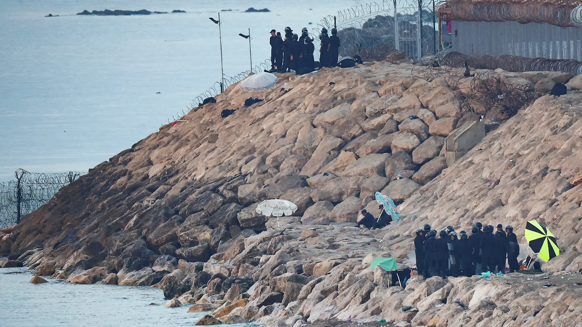 Moroccan security personnel secure the beach on the border with Spain in Ceuta, following mass crossings of migrants on foot and by sea from Morocco into Spanish territory, as seen from Ceuta, Spain, August 15, 2026. REUTERS/Pedro Nunes TPX IMAGES OF THE DAY