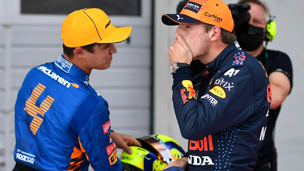 First place for pole position Red Bull driver Max Verstappen of the Netherlands, center, speaks with second place Mclaren driver Lando Norris of Britain at the end of the qualifying session ahead of the Austrian Formula One Grand Prix at the Red Bull Ring racetrack in Spielberg, Austria, Saturday, July 3, 2021. The Austrian Grand Prix will be held on Sunday. (Christian Bruna/Pool Photo via AP)