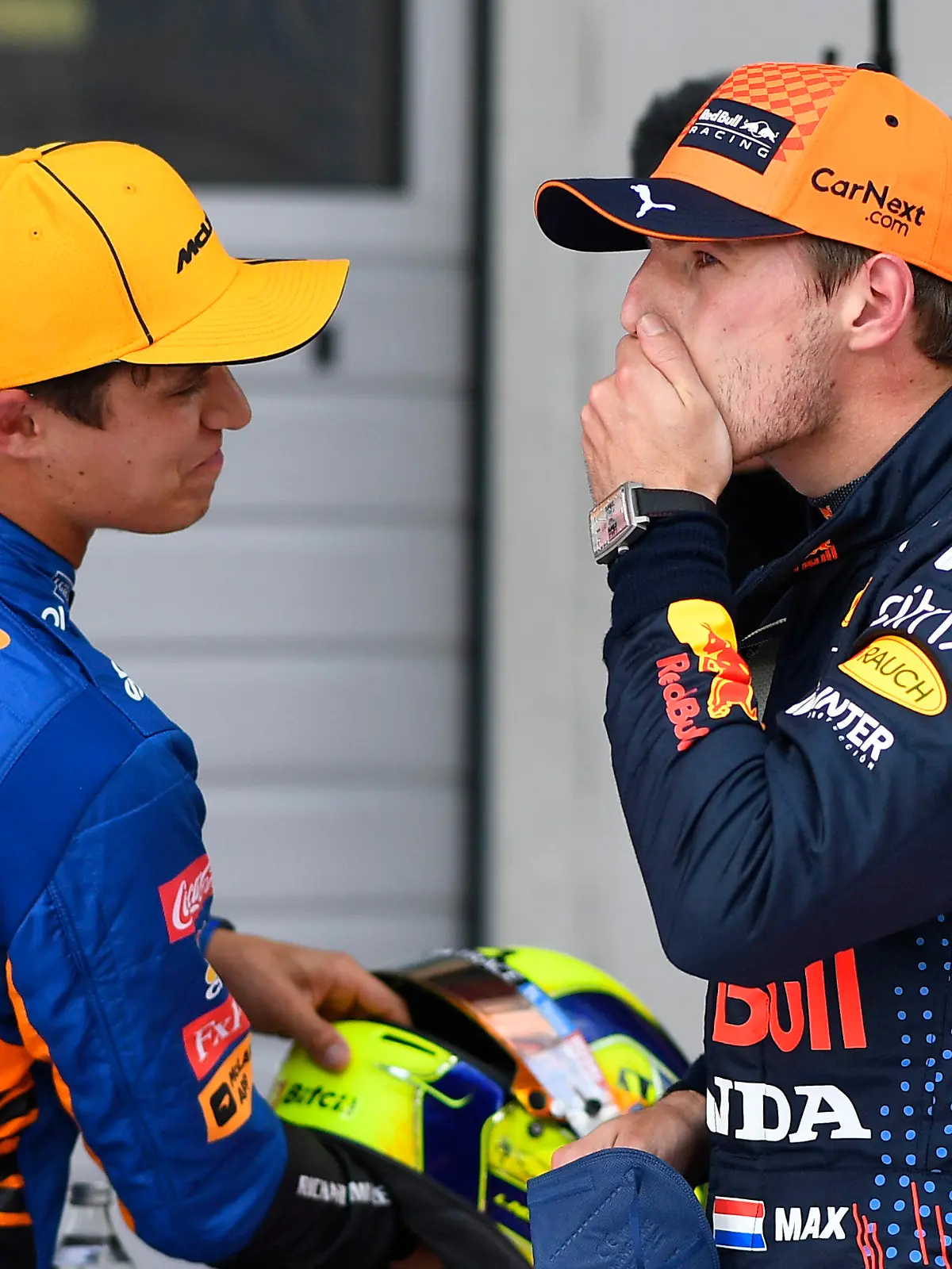 First place for pole position Red Bull driver Max Verstappen of the Netherlands, center, speaks with second place Mclaren driver Lando Norris of Britain at the end of the qualifying session ahead of the Austrian Formula One Grand Prix at the Red Bull Ring racetrack in Spielberg, Austria, Saturday, July 3, 2021. The Austrian Grand Prix will be held on Sunday. (Christian Bruna/Pool Photo via AP)
