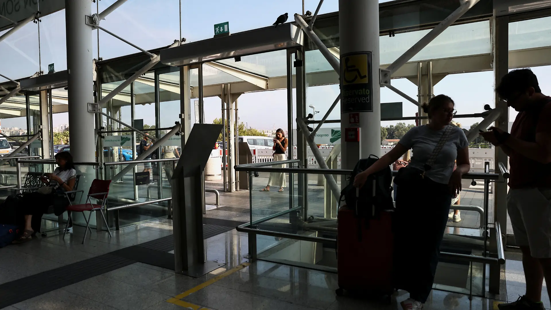 Passengers wait inside the terminal at Vincenzo Bellini Catania Airport following the closure of the airport due to an ash cloud from Sicily’s Mount Etna eruption in Catania, Italy, August 14, 2026. REUTERS/Matteo Minnella