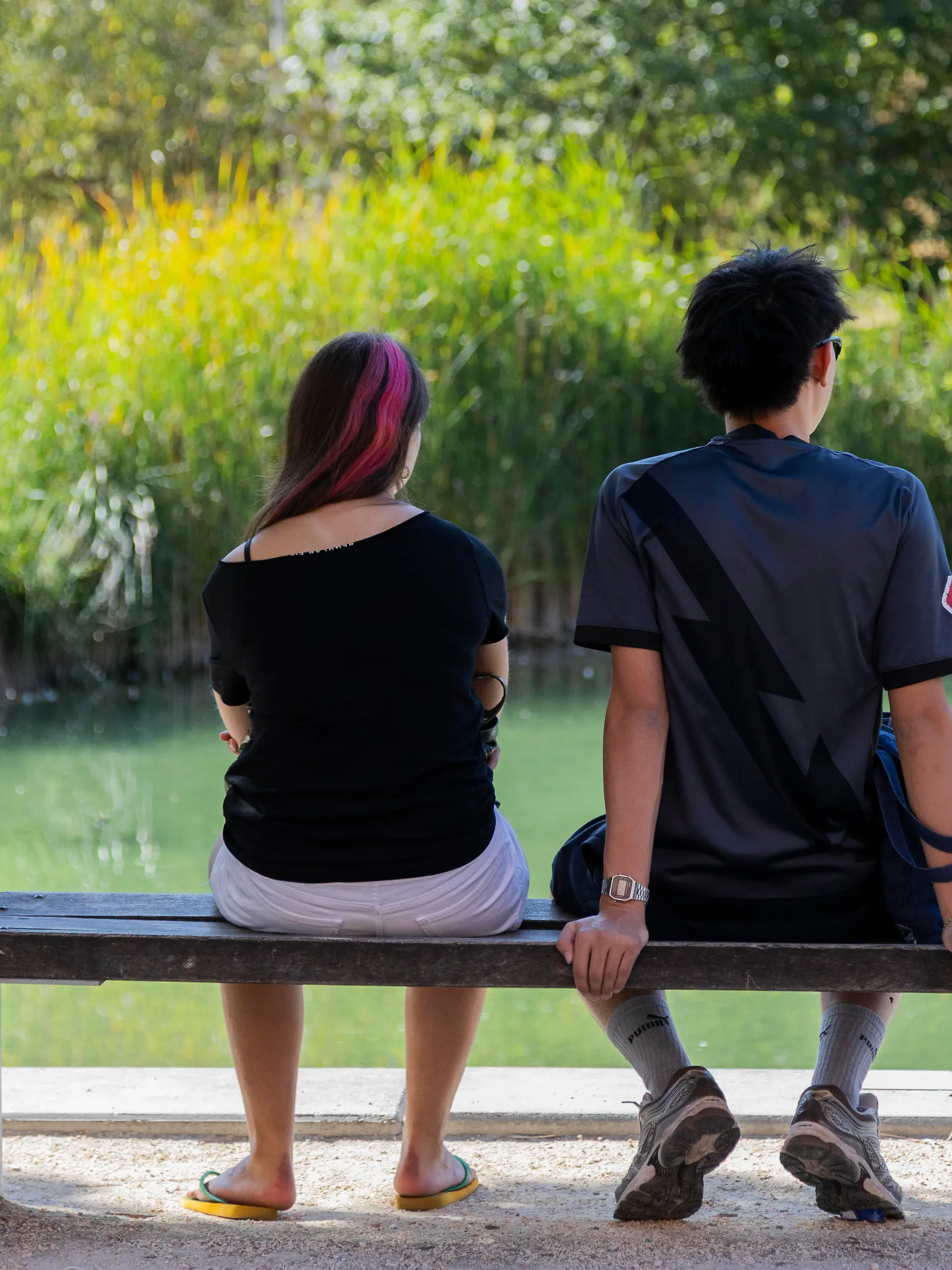 Two people sit in the shade beside a pond at the Ecoquartier de Bonne during a heatwave in Grenoble, Isere, Auvergne-Rhone-Alpes, France, August 12, 2026. Vegetation and water provide a cooler environment within the urban district during high summer temperatures. Deux personnes sont assises a ombre au bord de un bassin dans Ecoquartier de Bonne pendant une canicule a Grenoble, Isere, Auvergne-Rhone-Alpes, France, le 12 Aout 2026. La vegetation et eau offrent un environnement plus frais au sein du quartier urbain pendant les fortes temperatures estivales.