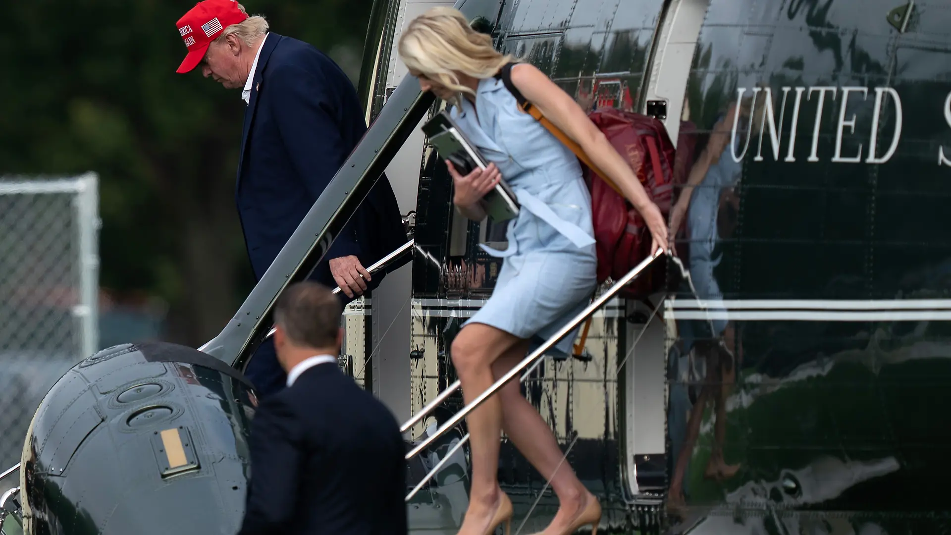 President Donald Trump and executive assistant Natalie Harp step off from Marine One upon they arrival at the Ellipse just outside of the White House, Sunday, Aug. 16, 2026, in Washington. (AP Photo/Jose Luis Magana)