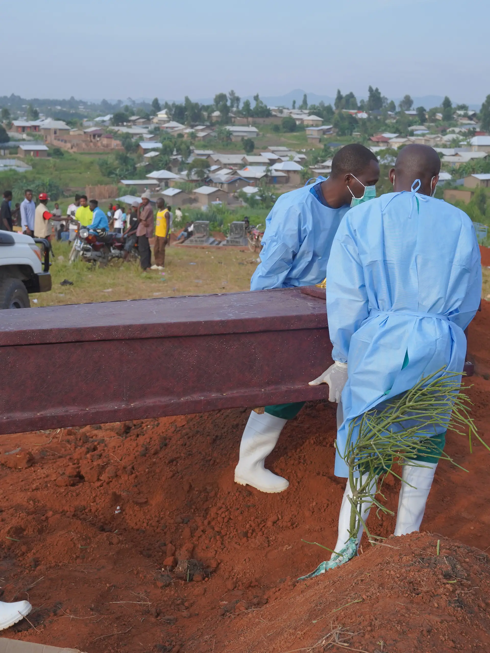 Menschen in Schutzkleidung laden einen Sarg mit den sterblichen Überresten eines sechsjährigen Kindes, das an Ebola gestorben ist, für eine Beerdigung in Bunia in der Provinz Ituri im Osten der Demokratischen Republik Kongo ab. +++ dpa-Bildfunk +++
