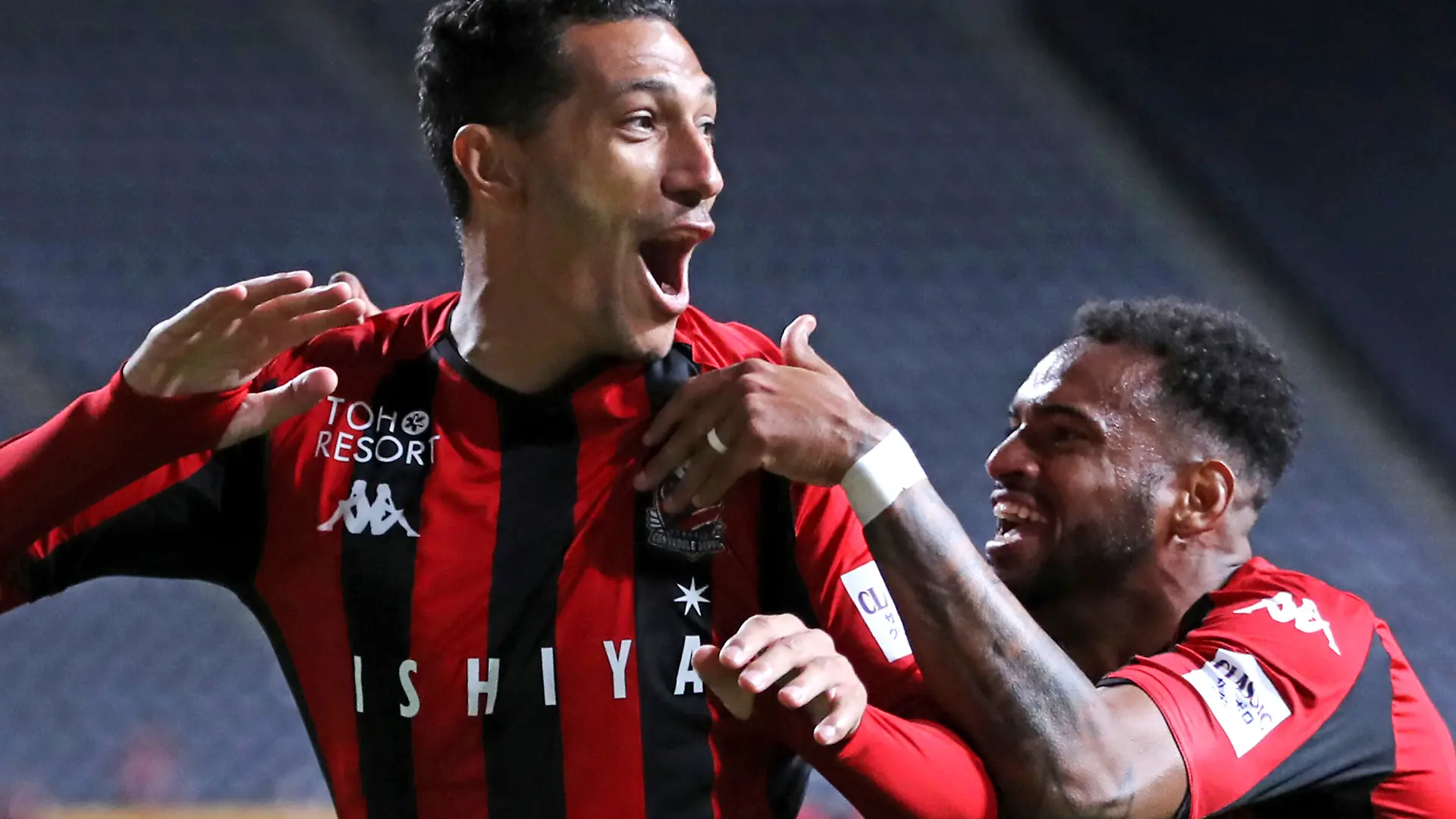 Jay Bothroyd, English forward of Hokkaido Consadole Sapporo, celebrates after scoring with Anderson Lopes (R) in the second half of the J1 League match against Sagan Tosu at Sapporo Dome in Sapporo City, Hokkaido Prefecture on November 14, 2020. Hokkaido Consadole Sapporo and Sagan Tosu drew by 1-1. ( The Yomiuri Shimbun via AP Images )