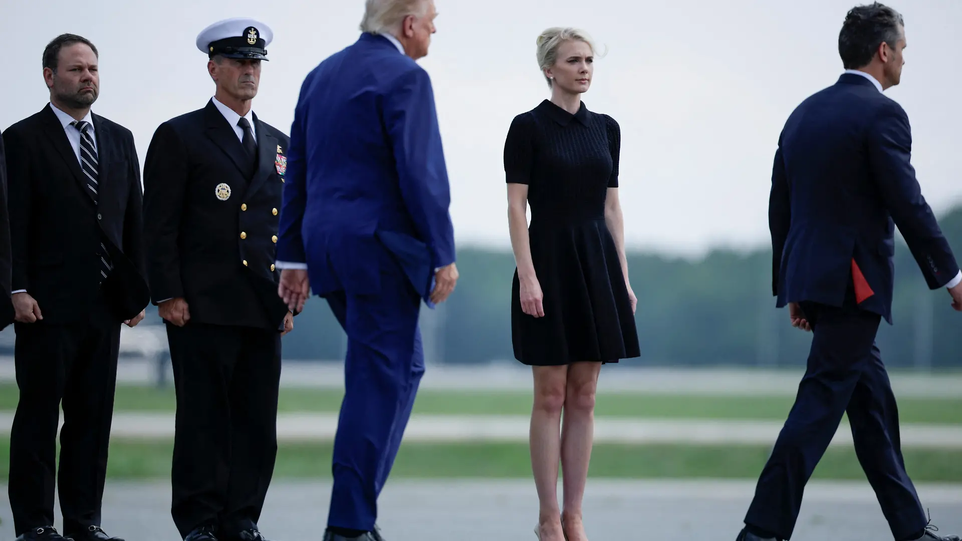 U.S. President Trump walks by his Executive assistant Natalie Harp as they attend a dignified transfer of the remains of U.S. Army service members, Army 1st Lt Tyler James Feehan, Sgt. Angel S. Rampersad, Pvt. Isabella Gonzales, killed during an attack on Muwaffaq Salti Air Base in Jordan, and Sgt. Michael Emmanuel Swinton, killed in action during a controlled detonation of a downed one-way unmanned aerial system at Erbil Air Base in Iraq, at Dover Air Force Base in Dover, Delaware, U.S., July 22, 2026. REUTERS/Evan Vucci