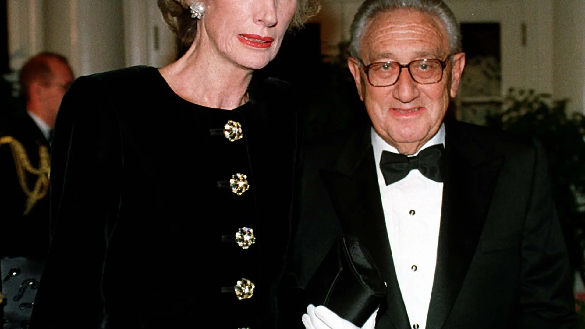 Former United States Secretary of State Dr. Henry A. Kissinger and his wife, Nancy, arrive at The White House in Washington, D.C. on October 29, 1997 for the State Dinner honoring President Jiang Zemin of China. Credit: Ron Sachs / CNP