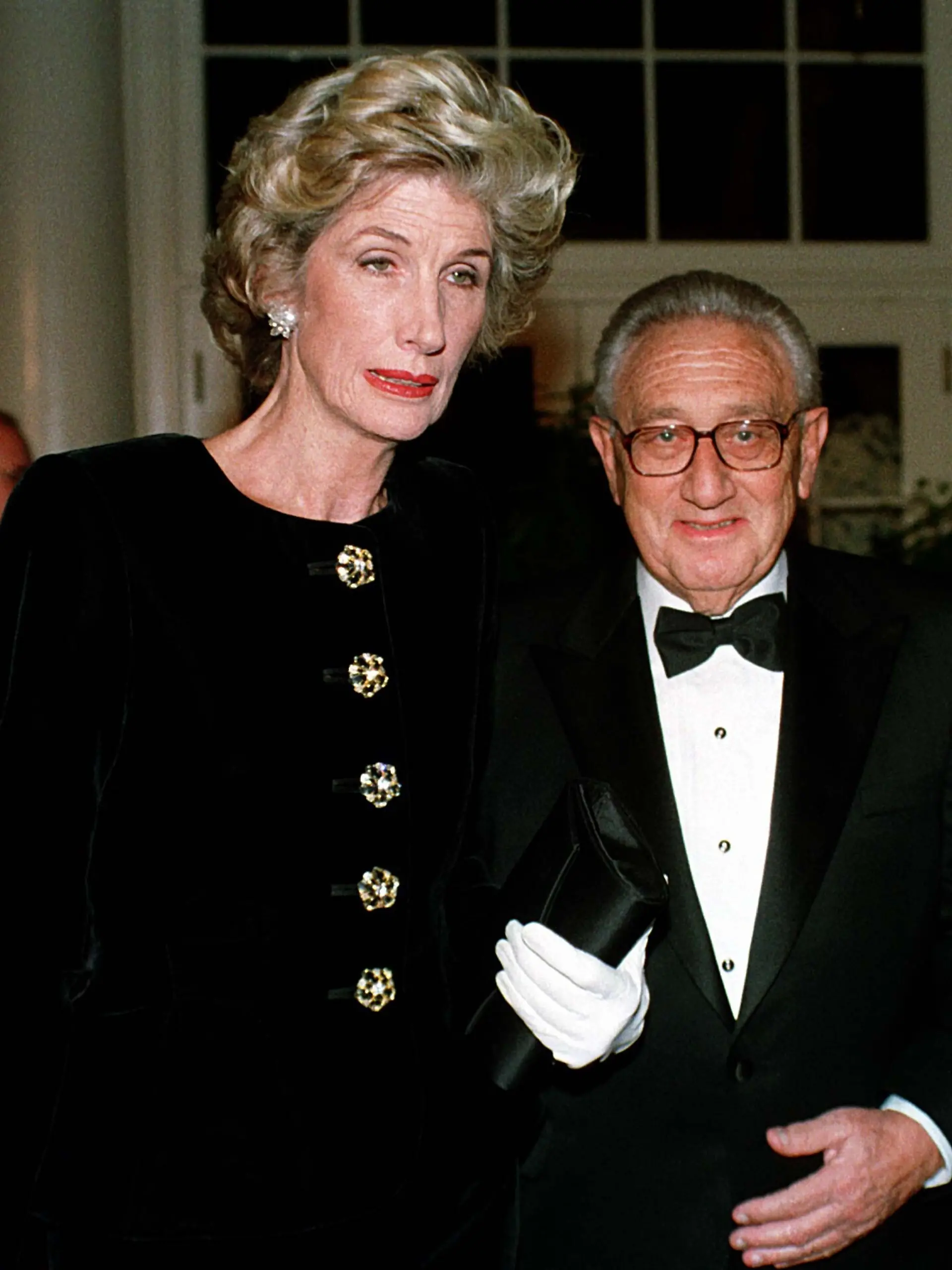 Former United States Secretary of State Dr. Henry A. Kissinger and his wife, Nancy, arrive at The White House in Washington, D.C. on October 29, 1997 for the State Dinner honoring President Jiang Zemin of China. Credit: Ron Sachs / CNP