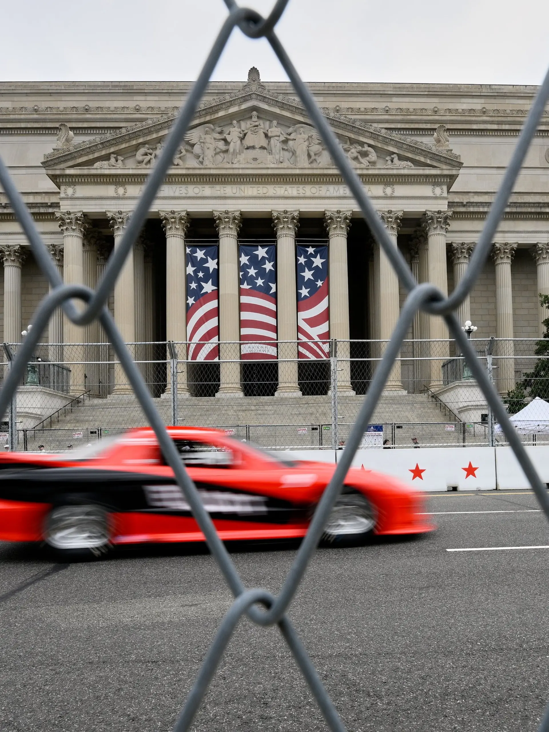 IROC cars drive past the National Archives building, prior to Sunday's Freedom 250 Grand Prix auto race in Washington, Saturday, Aug. 22, 2026. (AP Photo/Nick Wass)