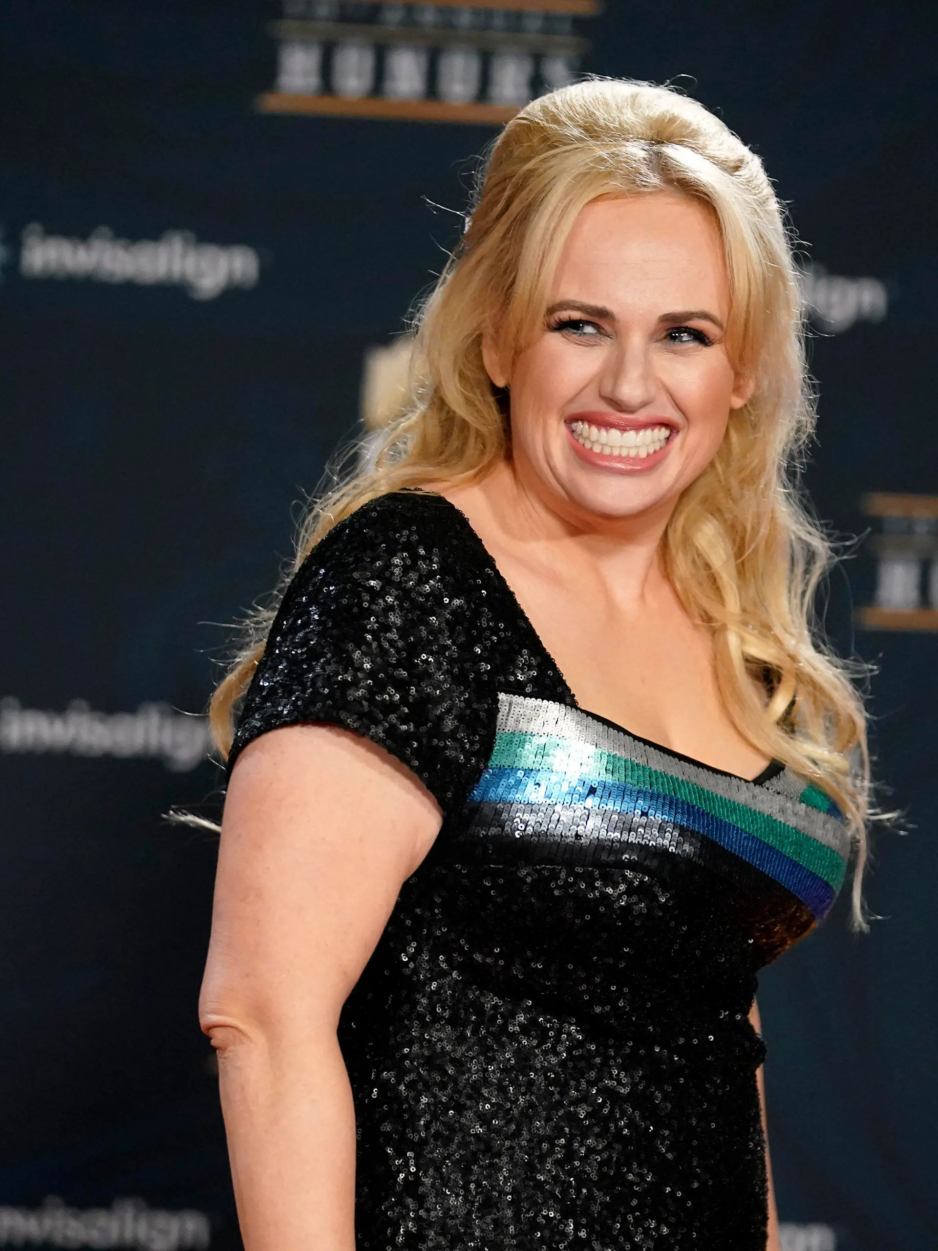 FILE - In this Tuesday, Feb. 2, 2021, file photo, Rebel Wilson poses on the red carpet during the NFL Honors football awards show, in Los Angeles. Wilson returns to her roots as host of ABC's “Pooch Perfect,” an eight-episode series featuring 10 dog groomers and their assistants competing in challenges. The show, which debuts March 30, is based on an Australian version. (AP Photo/Marcio Jose Sanchez, File)