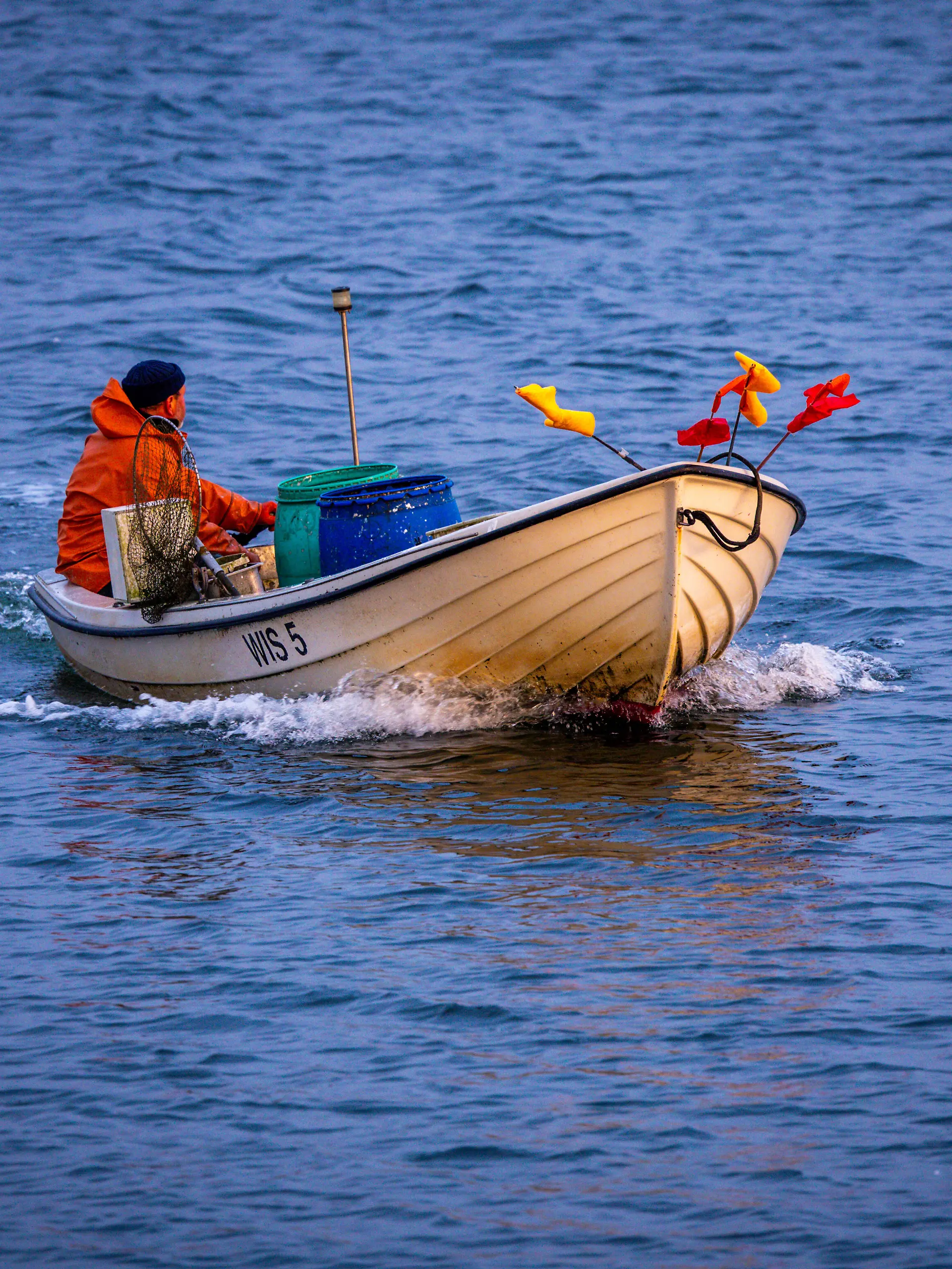 Ein Fischer fährt nach dem Einholen der Fangnetze mit seinem Boot bei Sonnenaufgang zurück in den Hafen. Wechselhaft und kühl zeigt sich das Wetter in Norddeutschland. +++ dpa-Bildfunk +++
