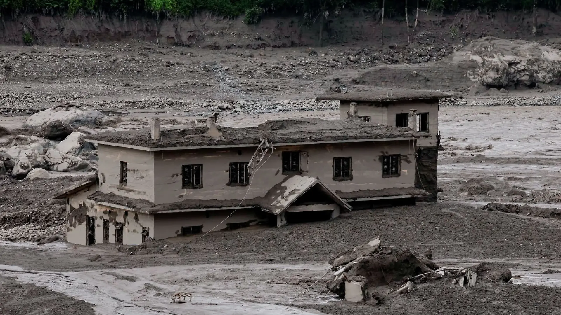 Mud covers a property following a flash flood at Trishuli, Nepal