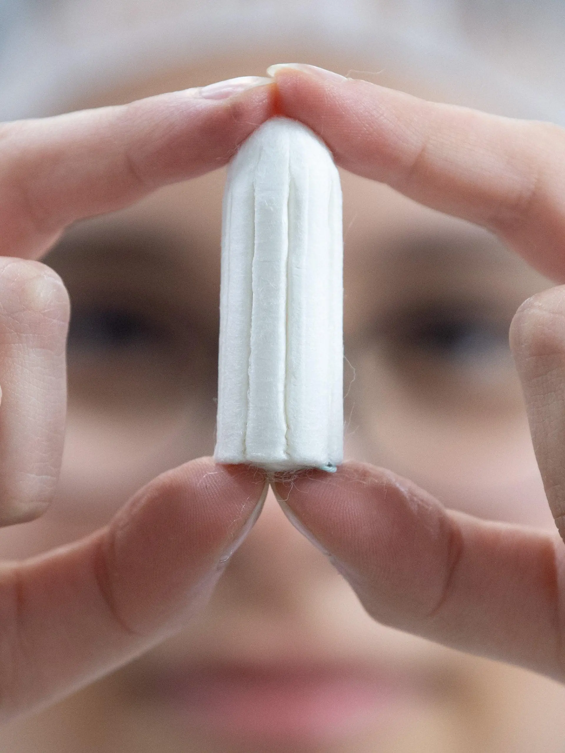 ARCHIV - 04.12.2019, ---: Ein Tampon wird von einer Angestellten in einer Produktionshalle gehalten. (Illustration zu dpa: "Binden und Tampons in Schottland bald kostenlos erhältlich") Foto: Sebastian Kahnert/dpa-Zentralbild/dpa +++ dpa-Bildfunk +++
