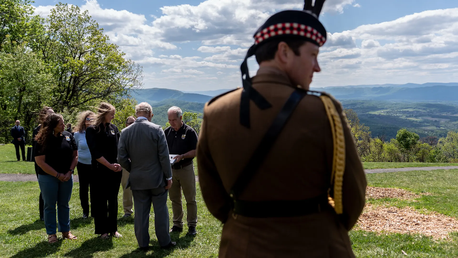Britain's King Charles III speaks with people outside Dickey Ridge Visitor Center as his equerry Lt. Col. Jonny Thompson, right, looks on, Thursday, April 30, 2026, at Shenandoah National Park in Front Royal, Va. (AP Photo/Julia Demaree Nikhinson, Pool)