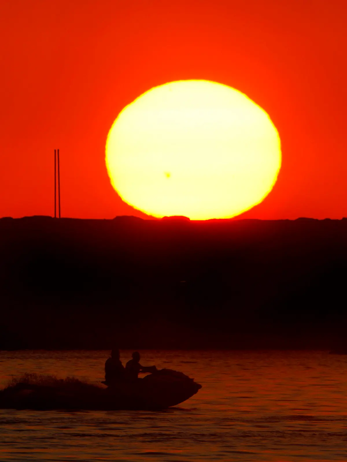 Two men ride a jet ski as the sun sets over the Mediterranean Sea coastline in Beirut, Lebanon, Wednesday, July 12, 2023. (AP Photo/Bilal Hussein)