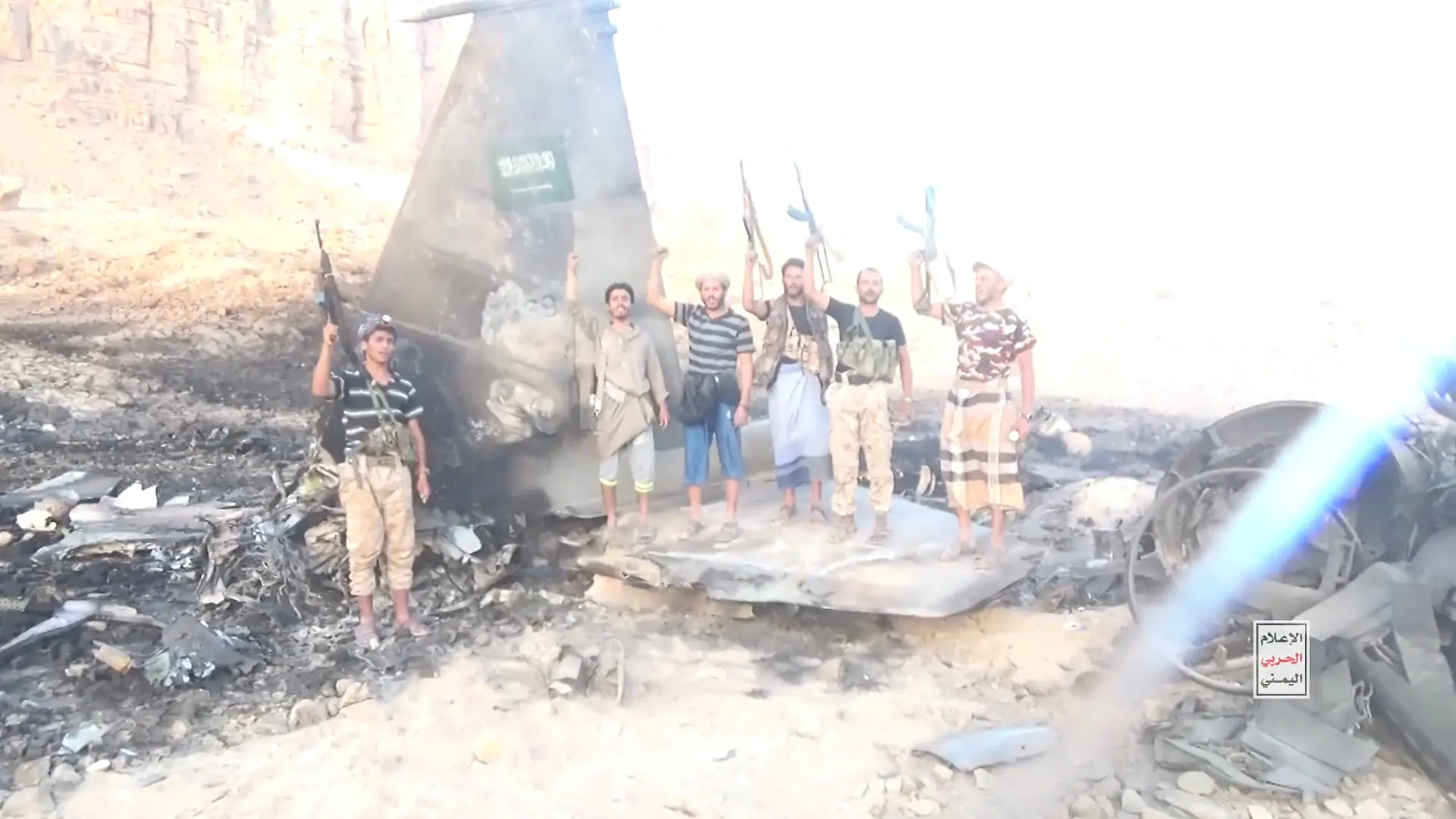 Houthi fighters stand infront of a downed Saudi Jet, in a location given as Yemen, in this screengrab from a handout video released on September 16, 2026. Houthi Military Media/ Handout via REUTERS THIS IMAGE HAS BEEN SUPPLIED BY A THIRD PARTY. Verification lines: The exact location and date when the video was filmed could not be verified. No older versions of the video were found posted online before September 16. Houthi military spokesman Yahya Saree said the Houthis had shot down a Saudi F-15 fighter jet. The extensive damage seen on the aircraft meant the model was not immediately identifiable. A Saudi Arabian flag is seen on the tail of the jet. The shape and discolouration of the debris is consistent across multiple shots and angles.