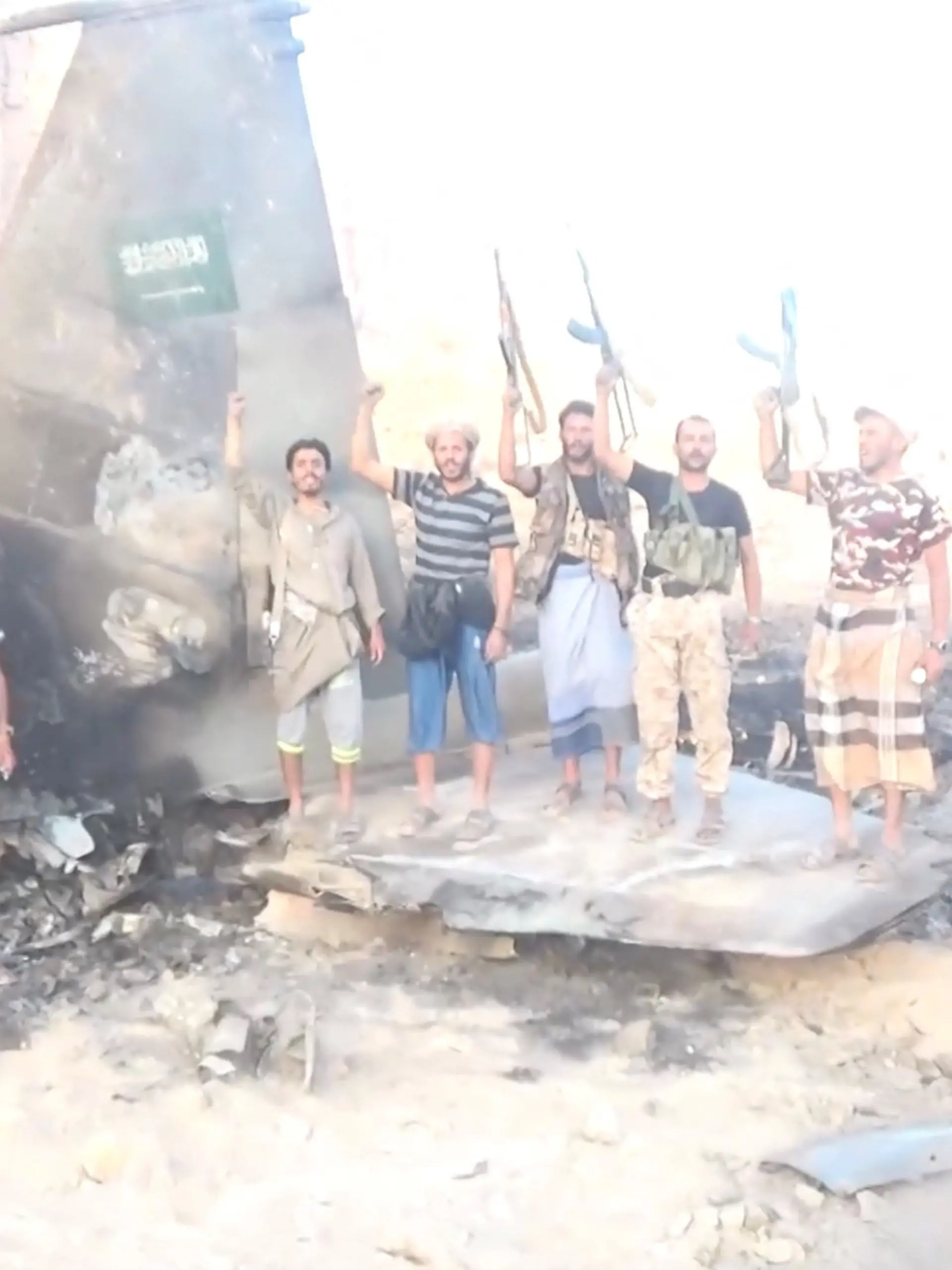 Houthi fighters stand infront of a downed Saudi Jet, in a location given as Yemen, in this screengrab from a handout video released on September 16, 2026. Houthi Military Media/ Handout via REUTERS THIS IMAGE HAS BEEN SUPPLIED BY A THIRD PARTY. Verification lines: The exact location and date when the video was filmed could not be verified. No older versions of the video were found posted online before September 16. Houthi military spokesman Yahya Saree said the Houthis had shot down a Saudi F-15 fighter jet. The extensive damage seen on the aircraft meant the model was not immediately identifiable. A Saudi Arabian flag is seen on the tail of the jet. The shape and discolouration of the debris is consistent across multiple shots and angles.