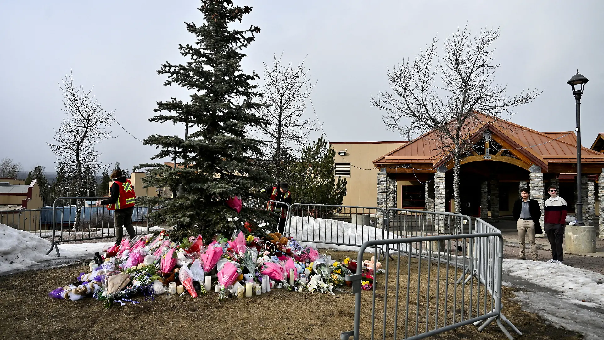 FILE PHOTO: Workers install a fence around a makeshift memorial for the victims two days after a deadly mass shooting took place at a school in the town of Tumbler Ridge, British Columbia, Canada, February 12, 2026. REUTERS/Jennifer Gauthier/File Photo