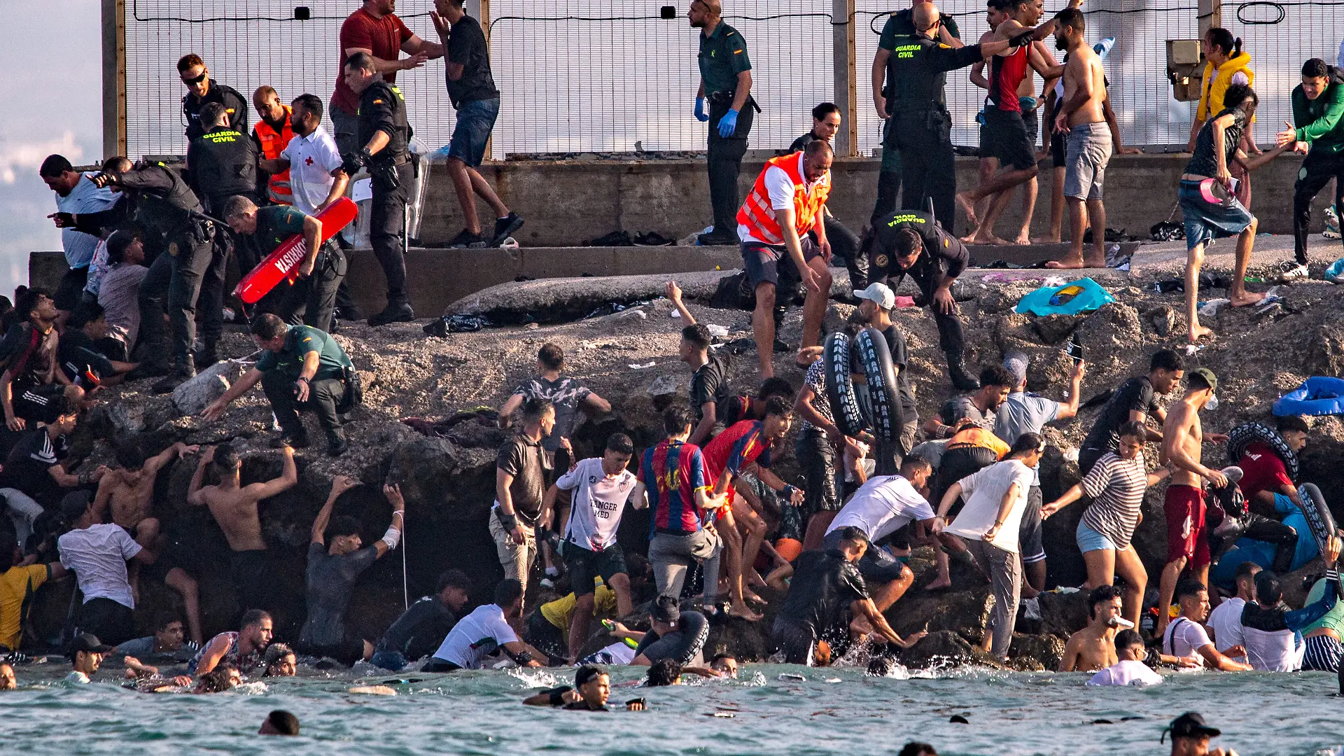 Migrants try to cross from Morocco into the Spanish enclave of Ceuta, Thursday, July 30, 2026. (AP Photo/Antonio Sempere)