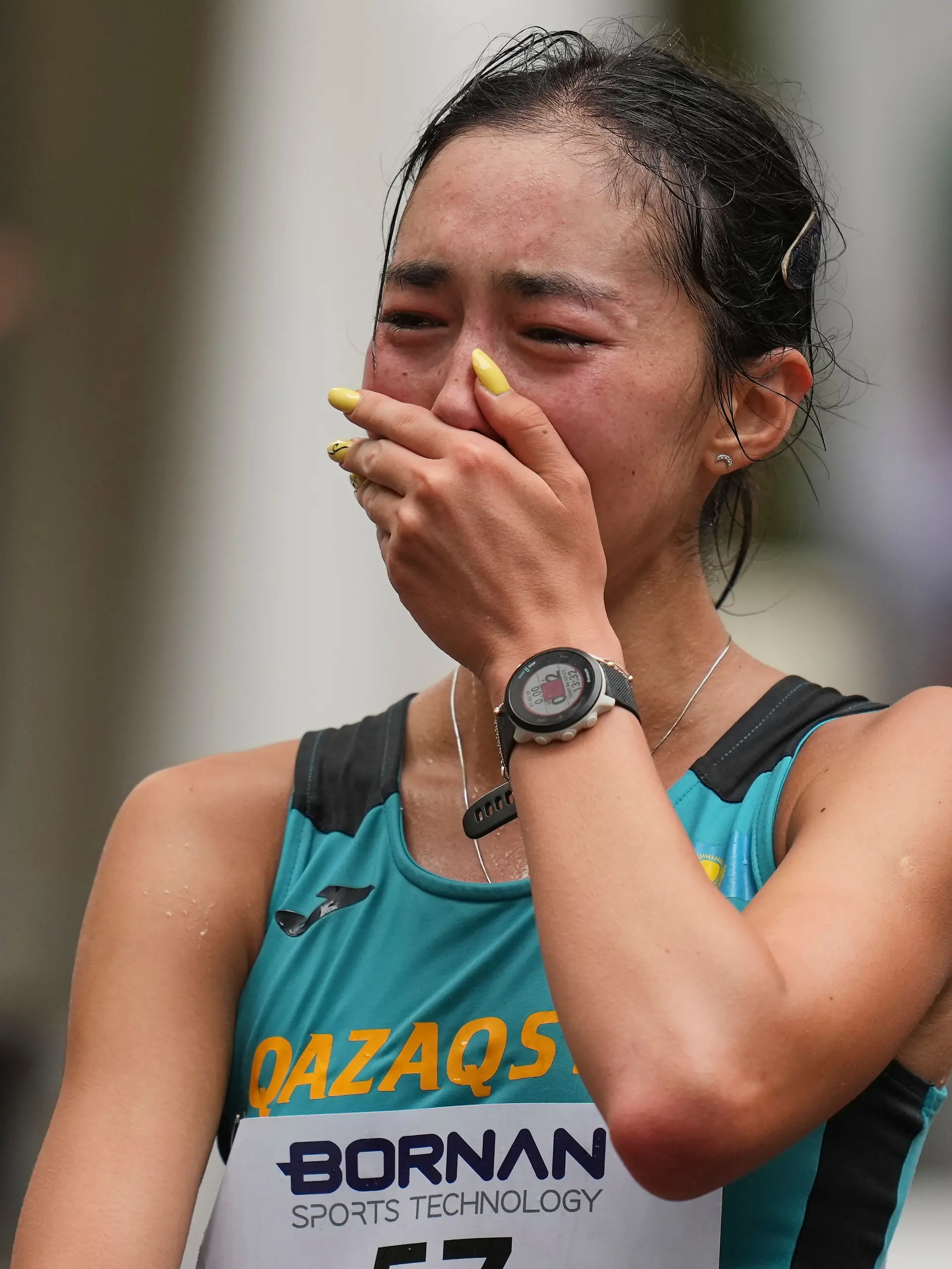 Kazakhstan’s Yasmina Toxanbayeva reacts after crossing the finish line to win the women’s marathon walk at the Asian Games in Nagoya, Japan, Sunday, Sept. 27, 2026. (AP Photo/Lee Jin-man)