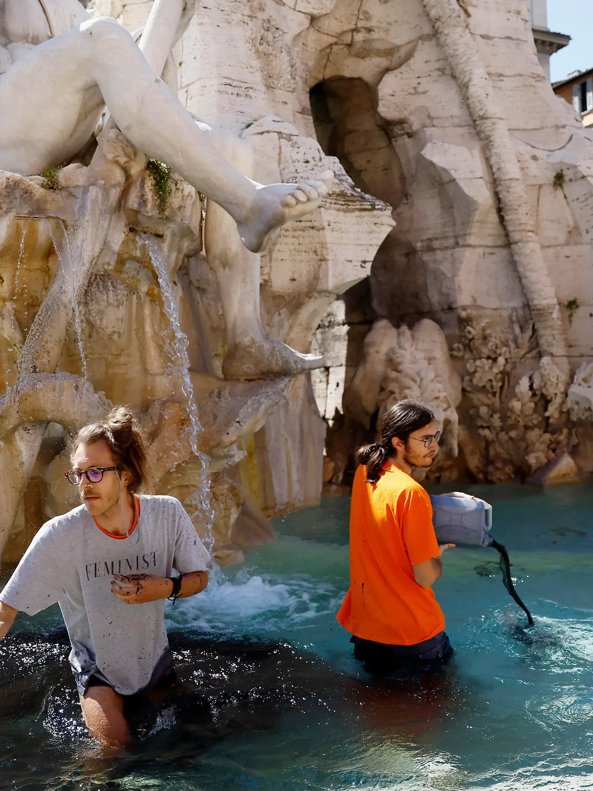 Activists of "Last Generation" stage a demonstration inside the Quattro Fiumi fountain, in Rome, Saturday, May 6, 2023. (Cecilia Fabiano/LaPresse via AP)