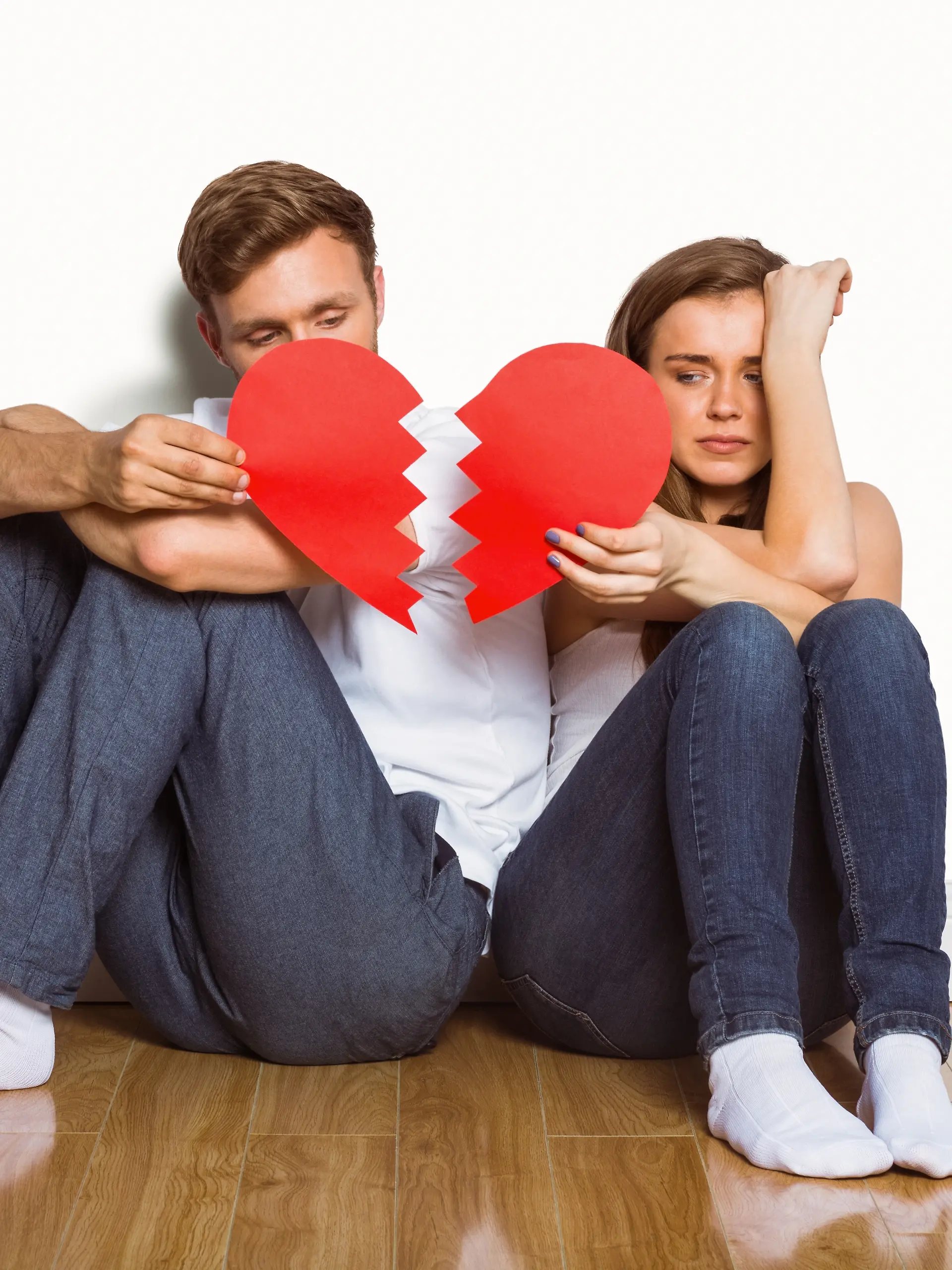 Young couple holding broken heart
