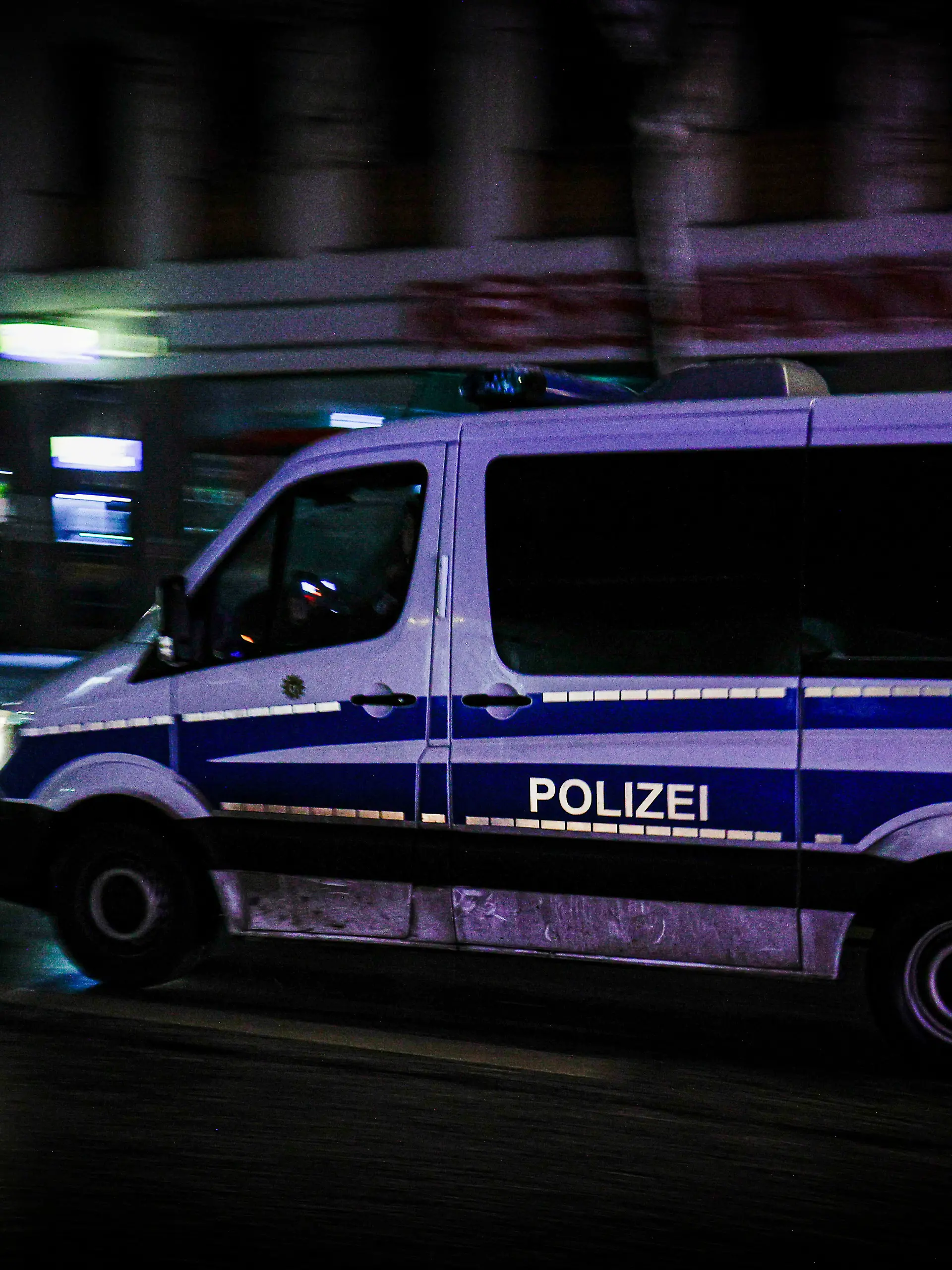 BERLIN, GERMANY - 2026/01/04: A police vehicle drives through darkened streets in the Zehlendorf district as large parts of southwestern Berlin remain affected by a power outage. Emergency services continue patrols in the area while residents face ongoing disruptions. A deliberate arson attack on high-voltage power cables at a bridge over the Teltow Canal in southwestern Berlin caused a blackout affecting 45,000 residents in Zehlendorf. The outage disrupted S-Bahn services and prompted authorities to open emergency shelters. Repairs are ongoing. (Photo by Vasily Krestyaninov/SOPA Images/LightRocket via Getty Images)