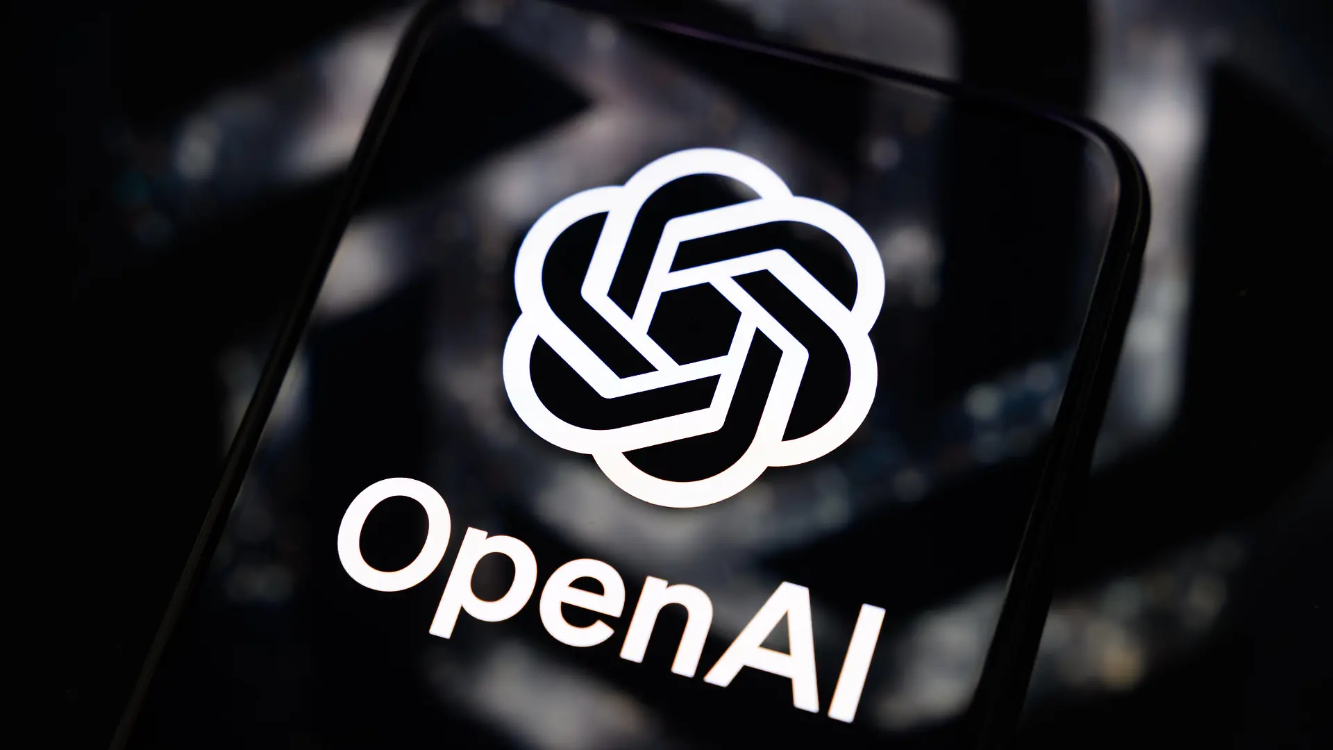 The OpenAI logo is displayed on a smartphone screen placed on a reflective surface on which the company's logo is projected in Creteil, France, on September 4, 2026, as OpenAI began rolling out GPT-6 Astra, its most advanced model to date. (Photo by Samuel Boivin/NurPhoto)