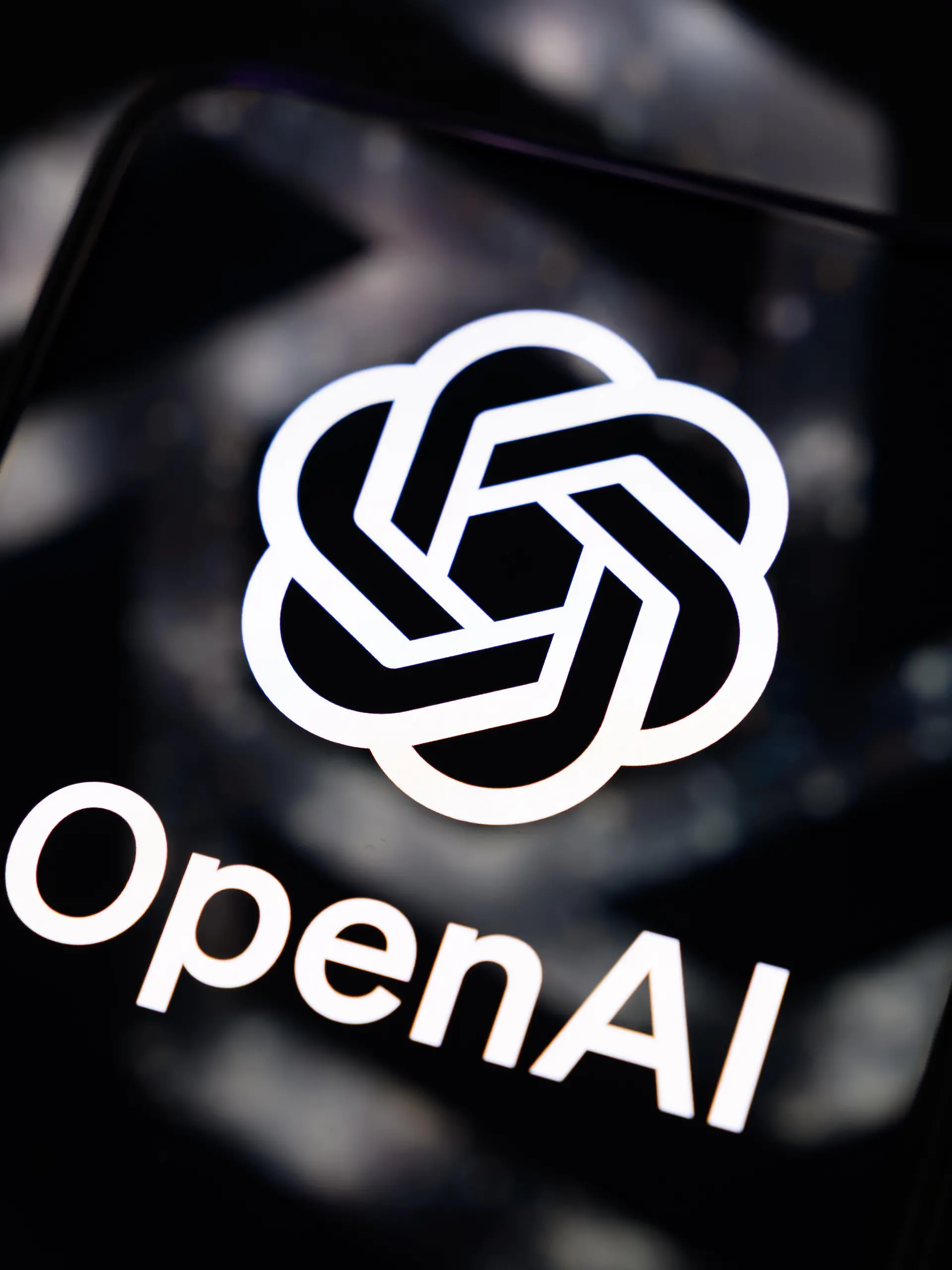 The OpenAI logo is displayed on a smartphone screen placed on a reflective surface on which the company's logo is projected in Creteil, France, on September 4, 2026, as OpenAI began rolling out GPT-6 Astra, its most advanced model to date. (Photo by Samuel Boivin/NurPhoto)