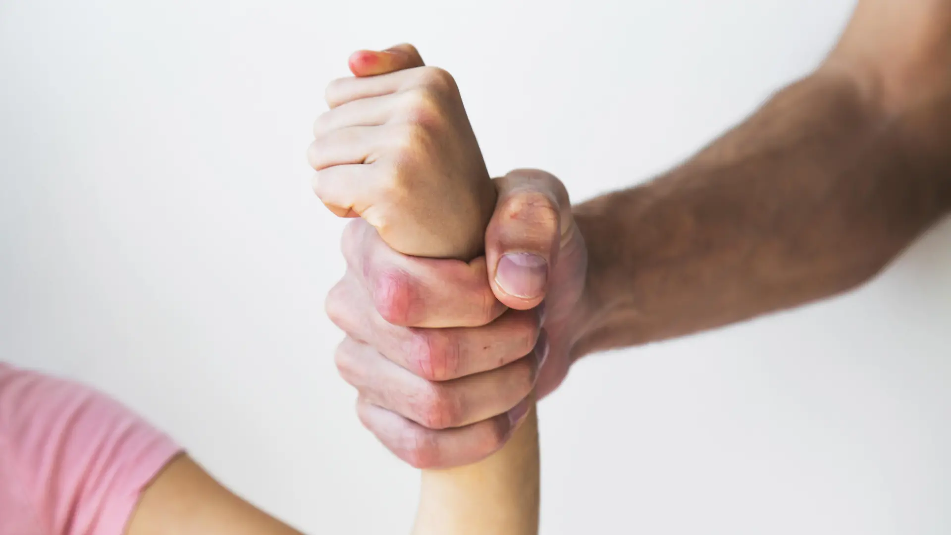 A strong adult hand tightly gripping a child's wrist, symbolizing domestic violence, abuse, and lack of freedom || Modellfreigabe vorhanden