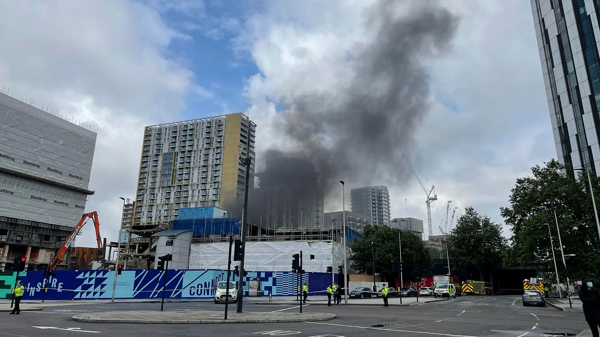 Emergency services at the scene of a fire that has broken out at garages close to Elephant and Castle railway station in London, Monday, June 28, 2021. Responding to videos posted on Twitter, the London Fire Brigade said Monday that 10 fire engines and 70 firefighters were battling the blaze at railway arches near the station, which is just south of the River Thames and near some major London landmarks, including the London Eye. (PA
via AP)