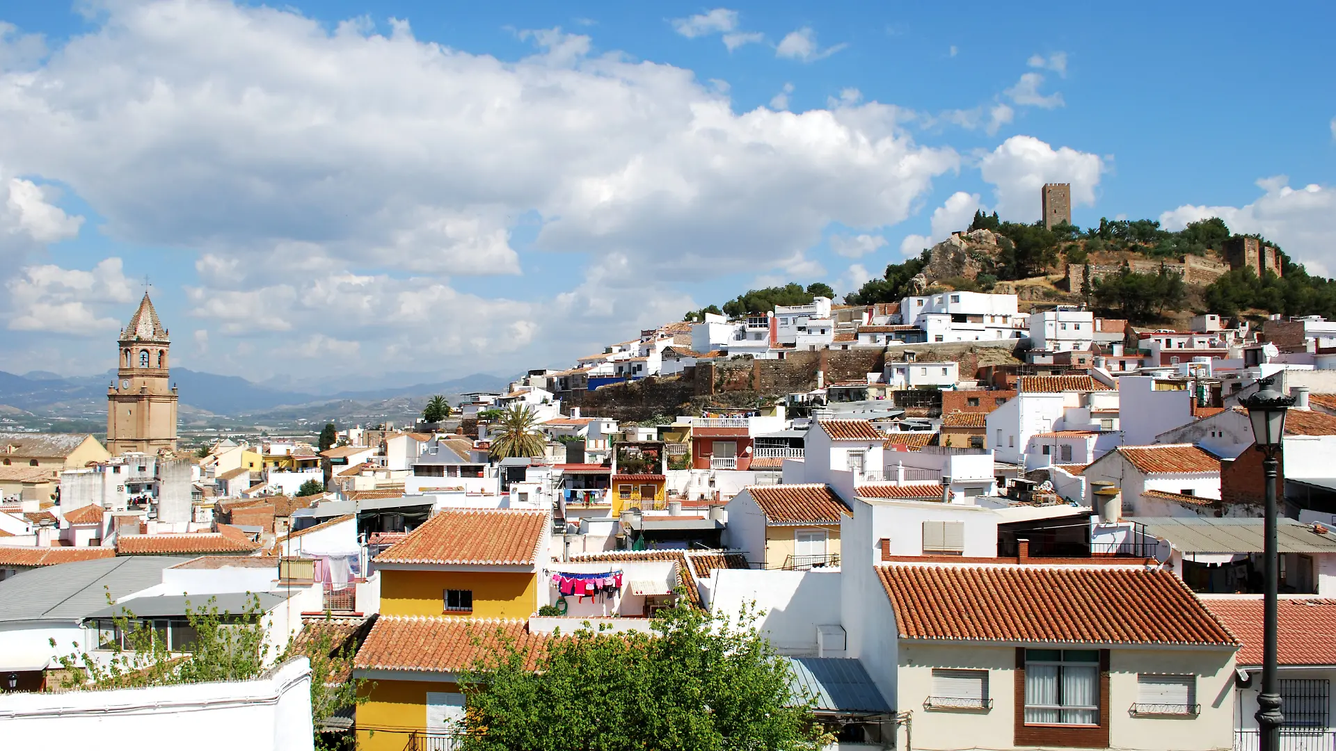 View of white town, Velez Malaga., View of church and town rooftops with the castle to the rear, Vel
