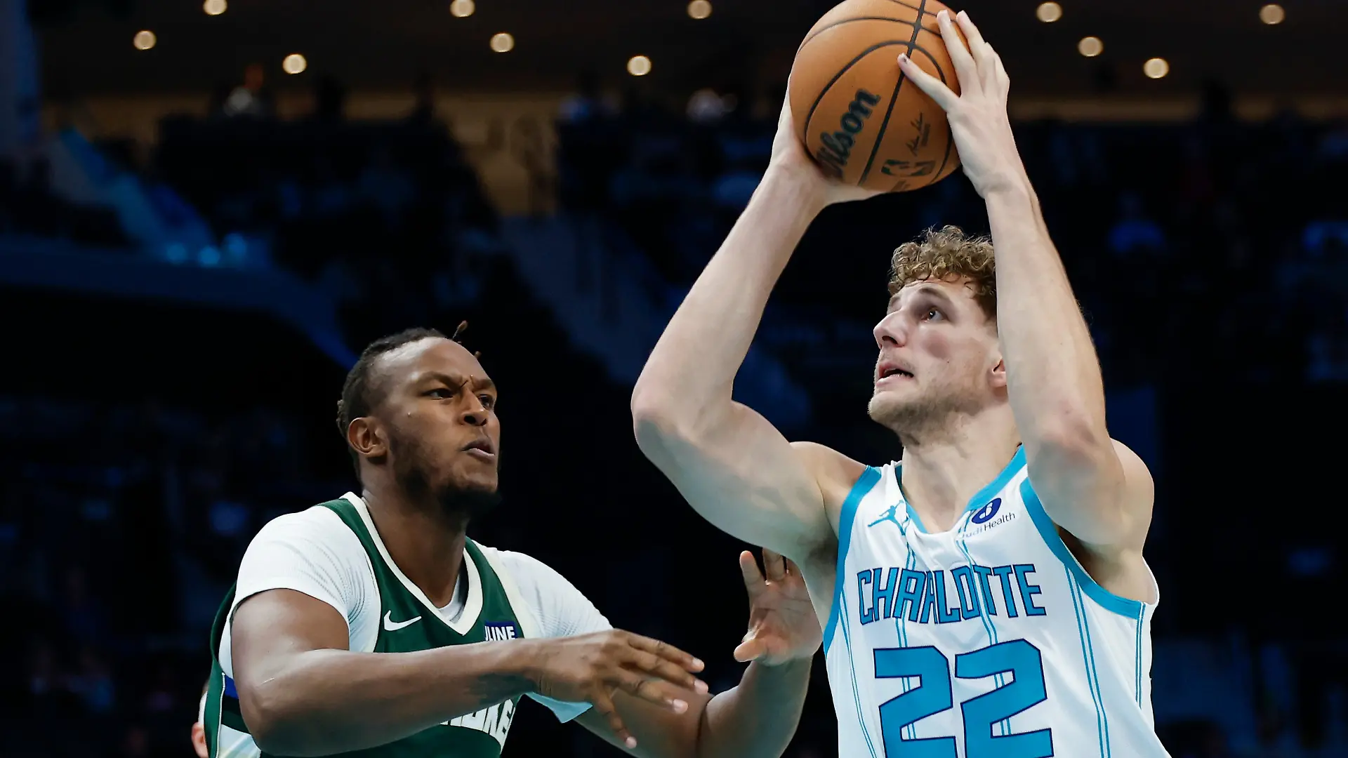 Charlotte Hornets forward Hannes Steinbach (22) drives to the basket against Milwaukee Bucks center Myles Turner during the second half of a preseason NBA basketball game in Charlotte, N.C., Sunday, Oct. 11, 2026. (AP Photo/Nell Redmond)