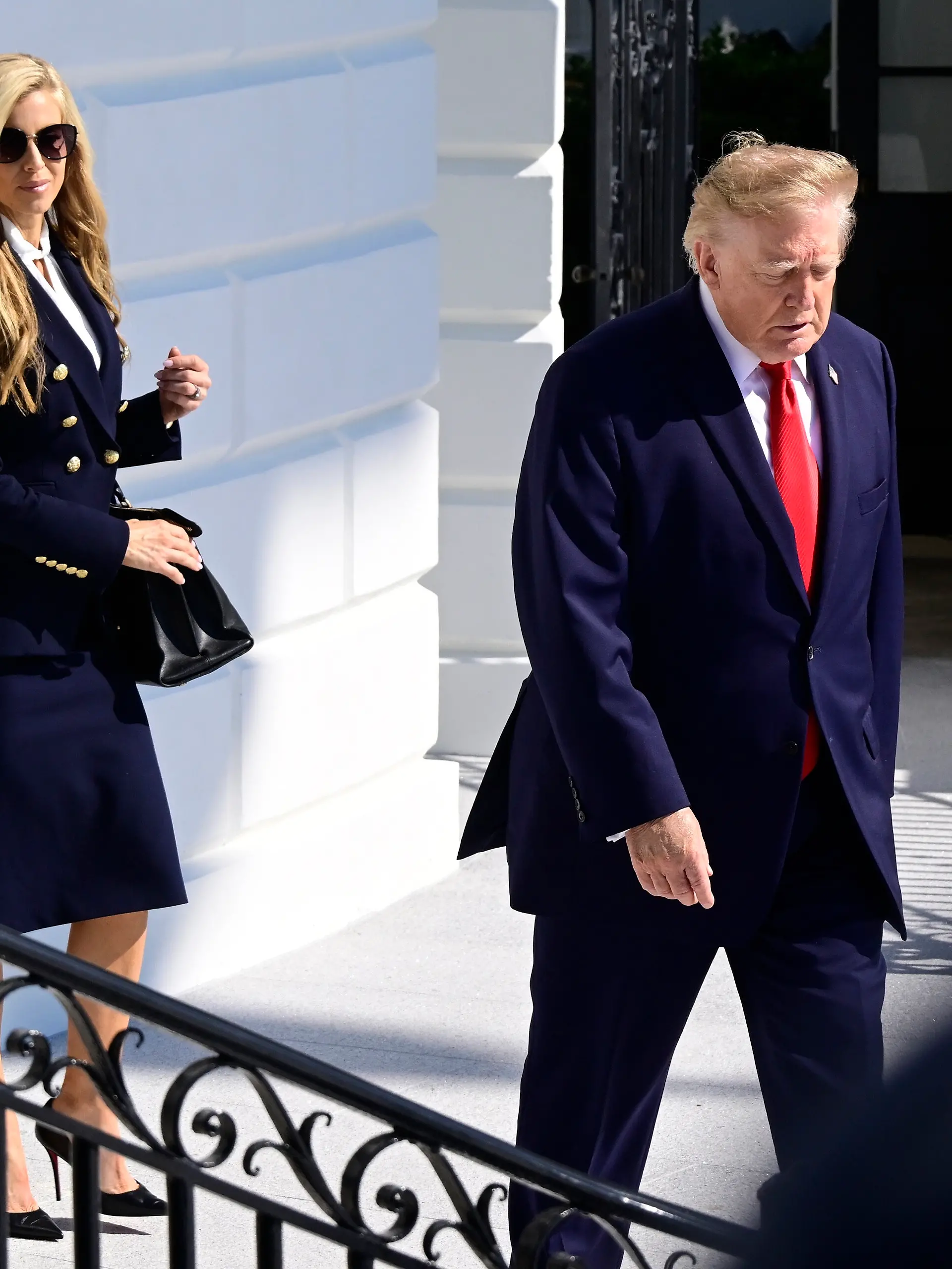 United States President Donald J Trump, followed by new White House Press Secretary Katie Zacharia, emerges from the Diplomatic Entrance as he departs for a campaign trip to Alaska, Nevada, Arizona and Montana from the South Lawn of the White House in Washington, DC, USA, on Tuesday, October 13, 2026. CAP/MPI/RS ©RS/MPI/Capital Pictures